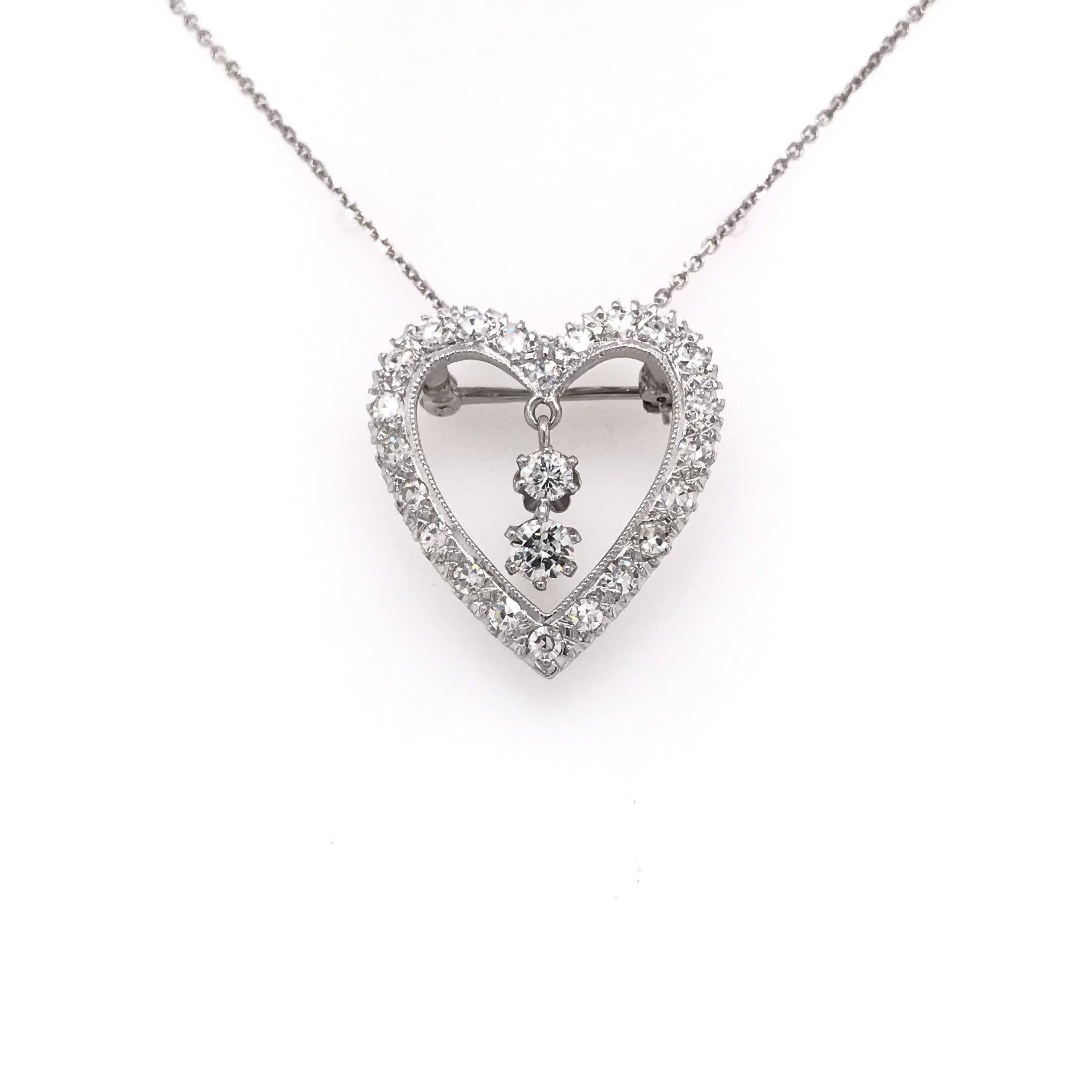 This gorgeous diamond heart pendant was crafted sometime during the Retro design period ( 1940-1960 ). The setting of the pendant is platinum and it can be worn as a pendant or a brooch. The pendant features 25 sparkling round diamonds as well as