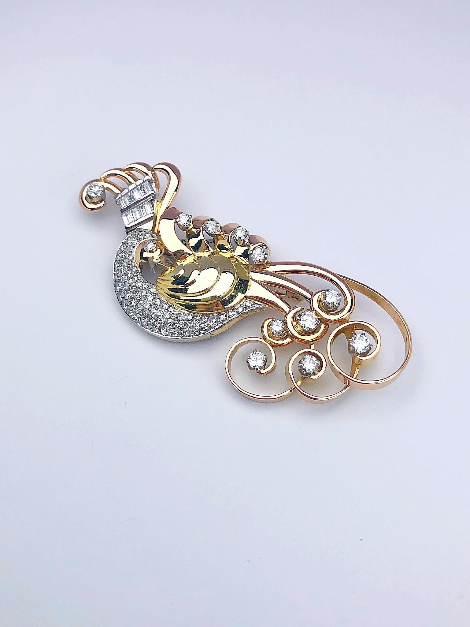 Circa 1940's retro brooch. An artistically designed peacock . His yellow gold body is set with diamond pave, his rose gold tail feathers are set with brilliant cut diamonds and his crown is set with baguette cut diamonds. 3