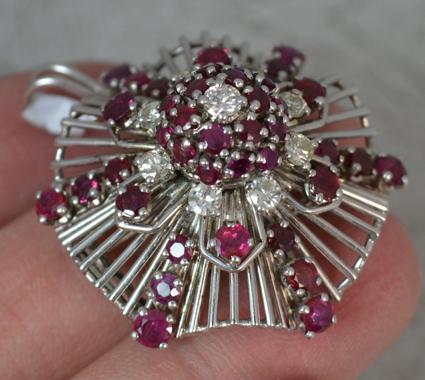A fantastic Platinum, Ruby and Diamond cluster pendant and brooch.
Designed with nine vs1 grade round brilliant cut diamonds with multiple round cut rich red rubies.
Amazing retro design with many plain platinum bars running throughout.

Condition;