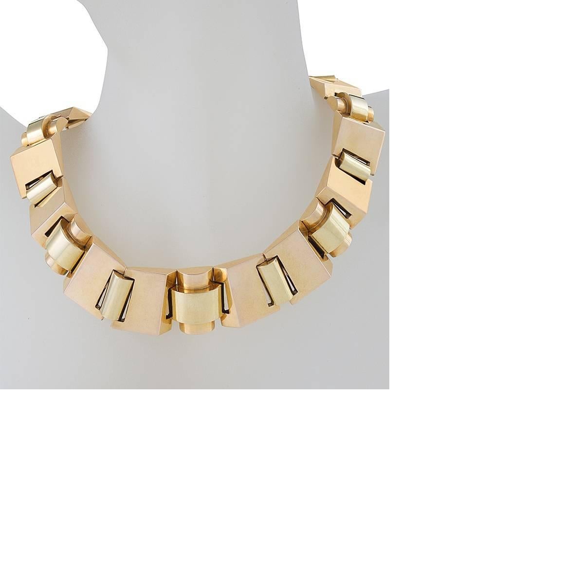 A Retro 18 karat polished gold necklace. This unique necklace is designed in a strong geometric link motif. This 'tank track' necklace is an exceptionally rare expression of this jewelry style. 

Following World War II, jewelry makers in Europe and