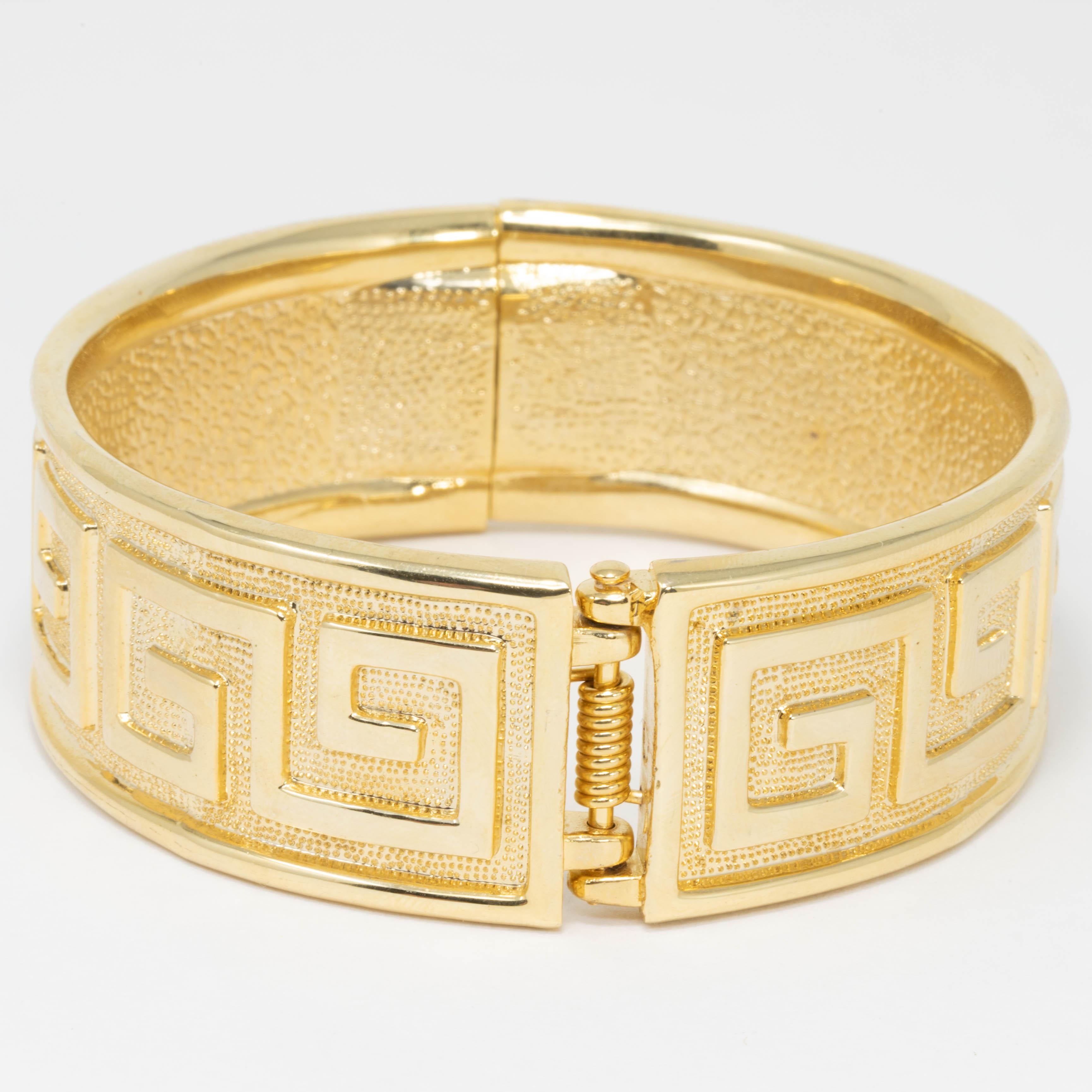 A bold gold bacelet! This stylish bangle features textured goldtone texture with raised abstract motifs.

Inner circumference: 7.75 in / 19.5 cm
Inner diameter: 2.5 in / 6.5 cm