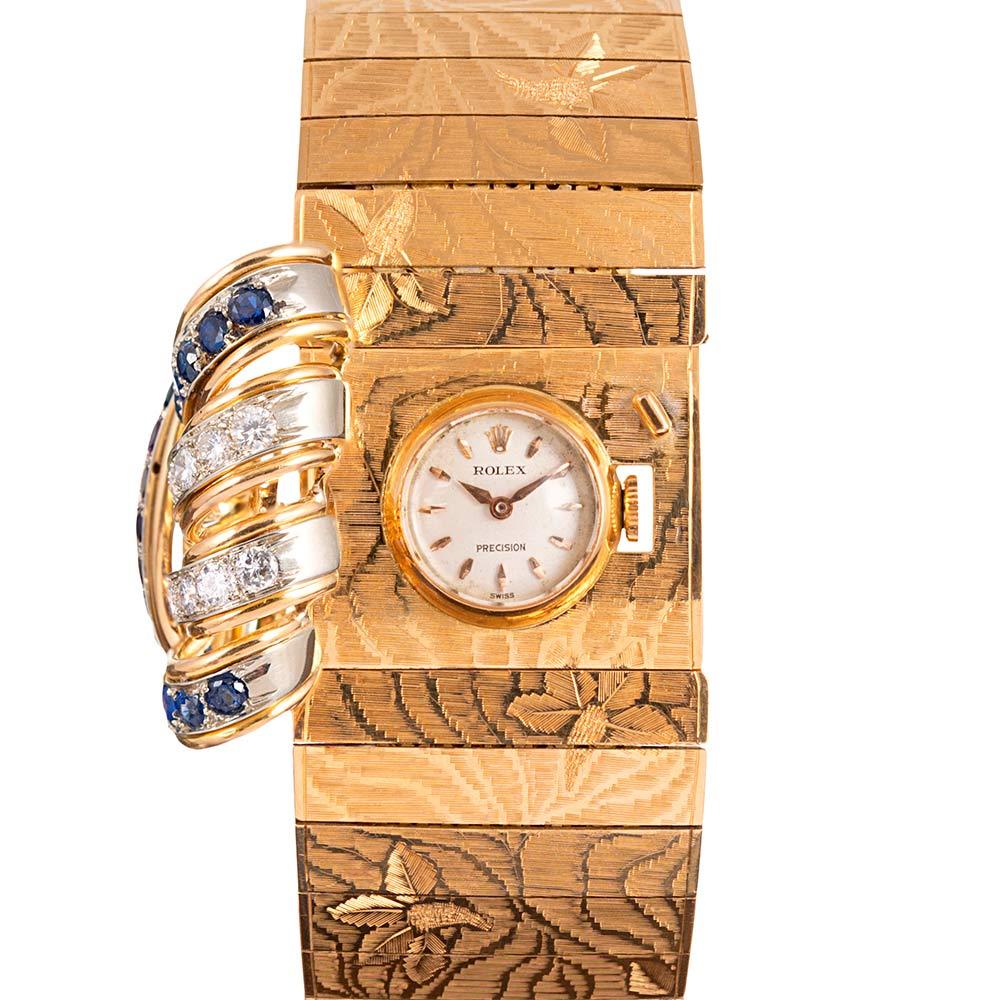 An important and larger-than-average lady’s mid-century wrist watch with a closed cover, decorated with a scrolling burst of intense blue sapphires and brilliant white diamonds. The interest of this piece is augmented beyond its fashion value by the