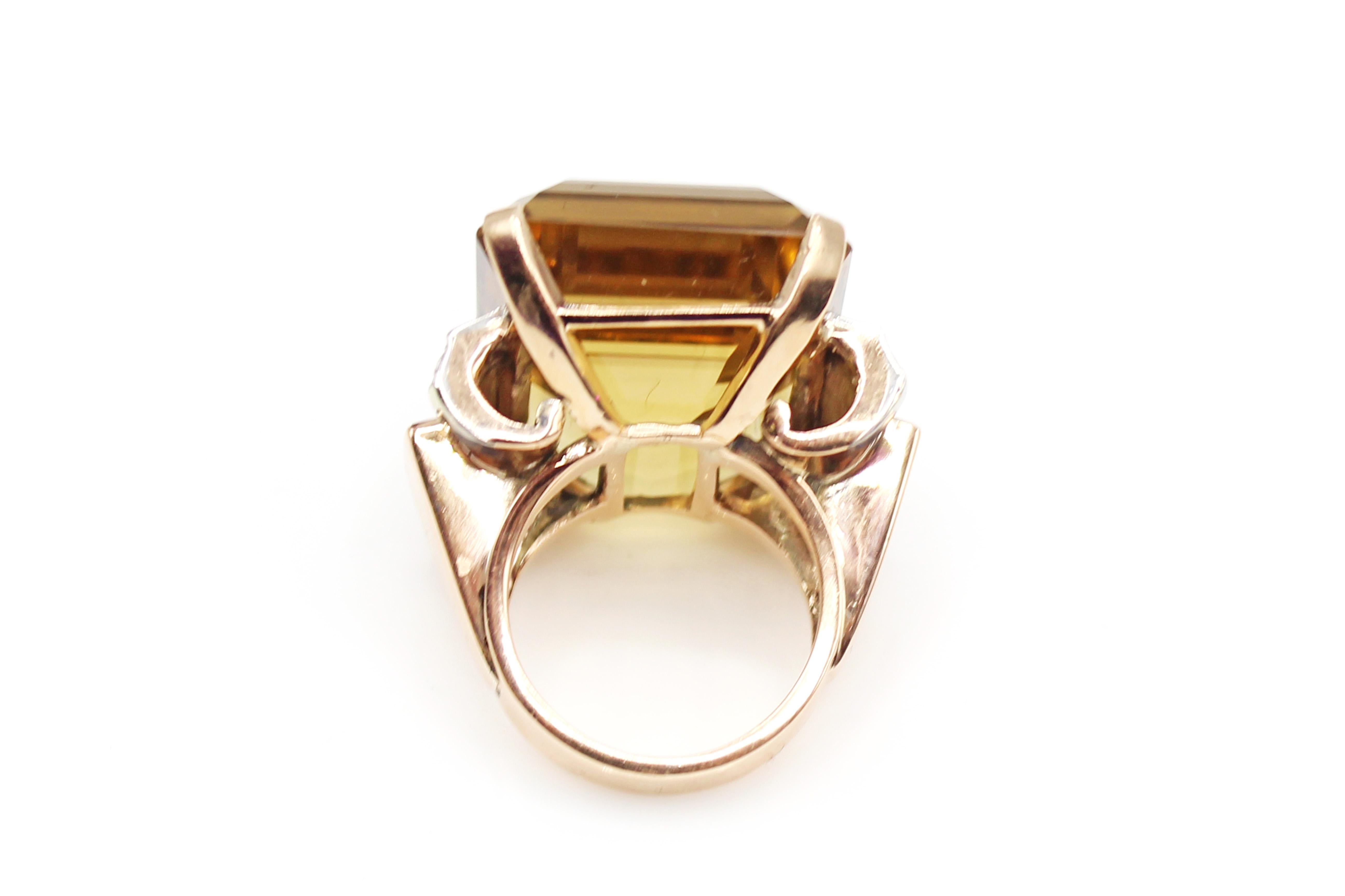 Impressive golden Citrine rose gold diamond ruby ring, centrally set with one emerald cut Citrine measured to weigh approximately 45 carats. The beautiful cut and crystal of this gem stone give it an amazing fire and brilliance which is enhanced by