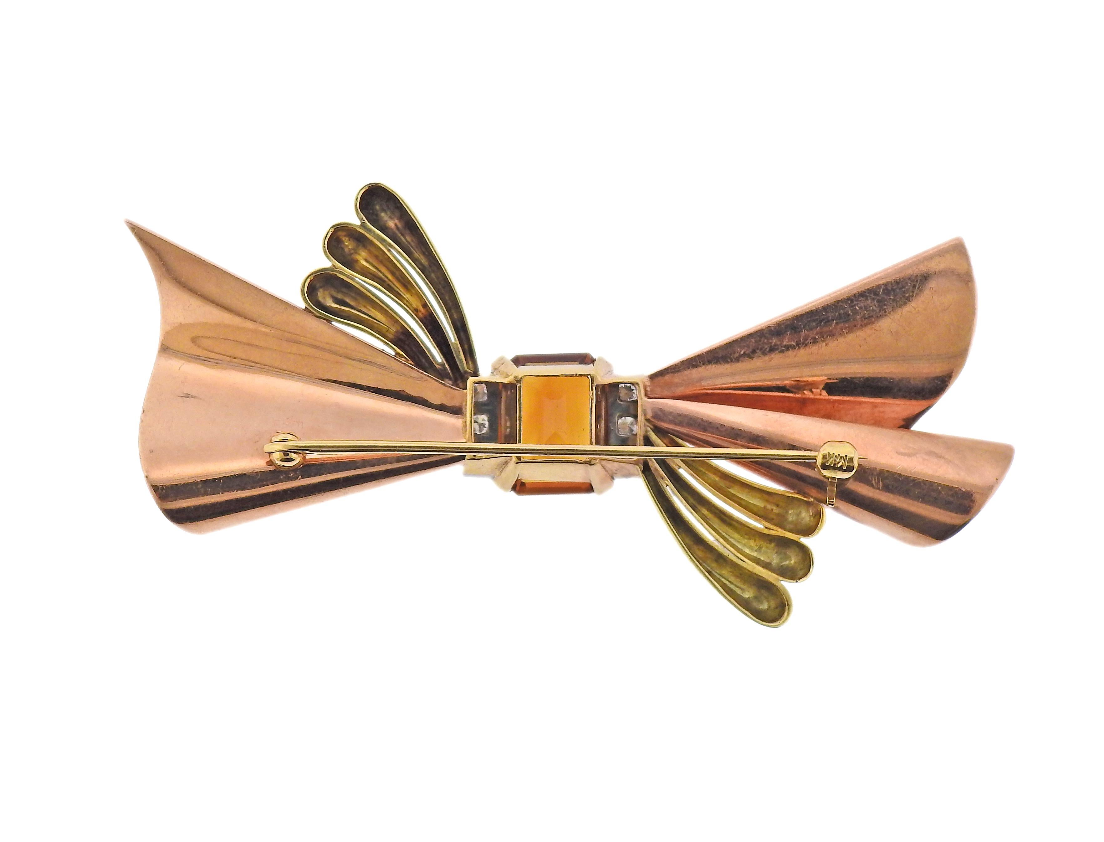 Retro classic bow brooch, set in 14k rose, yellow and white gold. Featuring 12.1 x 9.8mm citrine, and approx. 0.18ctw in diamonds. Brooch is 75mm x 38mm. Marked 14k. Weight - 18.6 grams. 