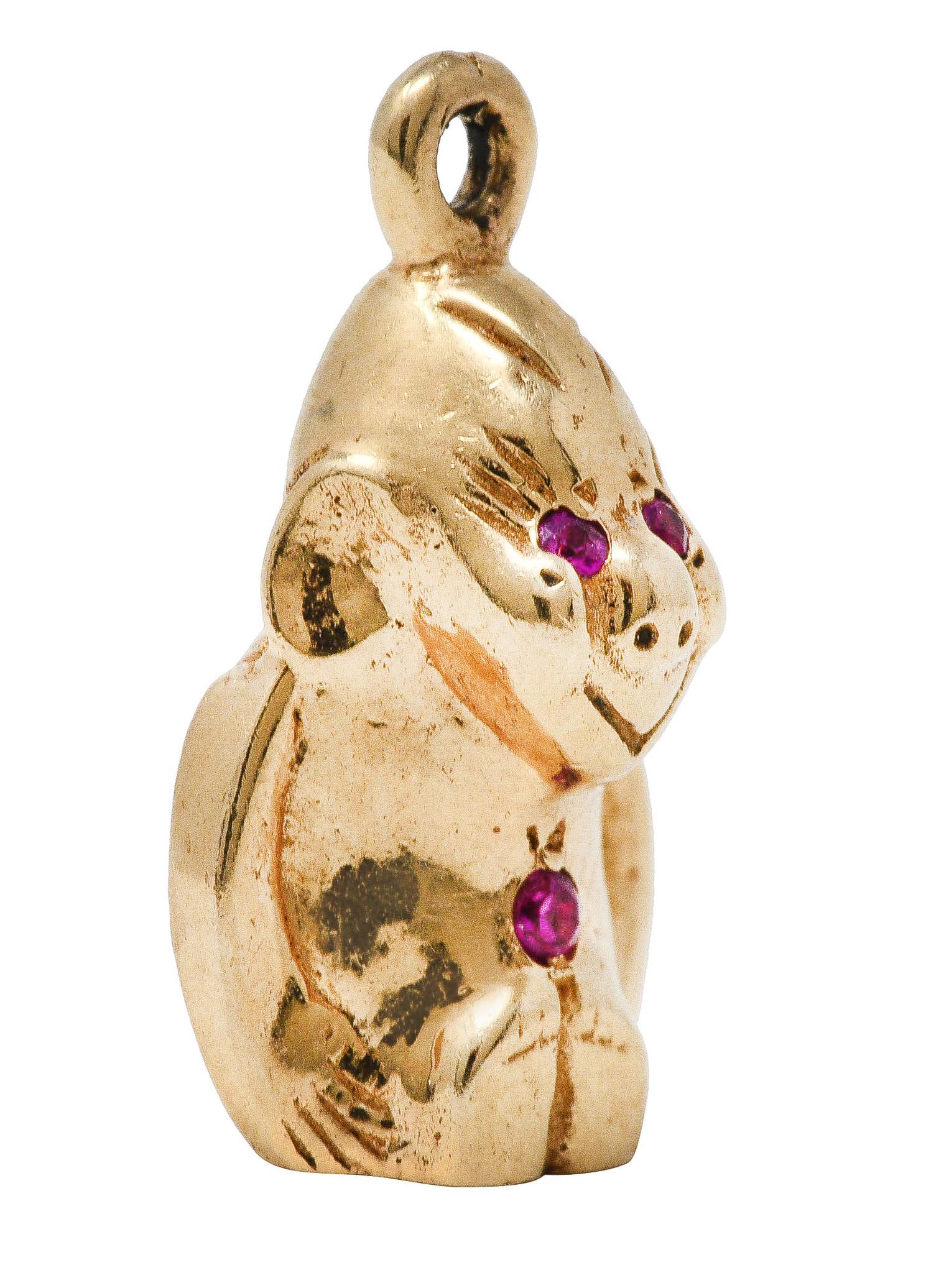 Designed as stylized sitting gorilla with carved features

Accented by three round cut rubies - well matched and bright

Completed by bale

Tested as 14 karat gold

Circa: 1940's

Measures: 3/8 x 6/8 inch

Total weight: 5.0 grams

Cheeky. Saucy.