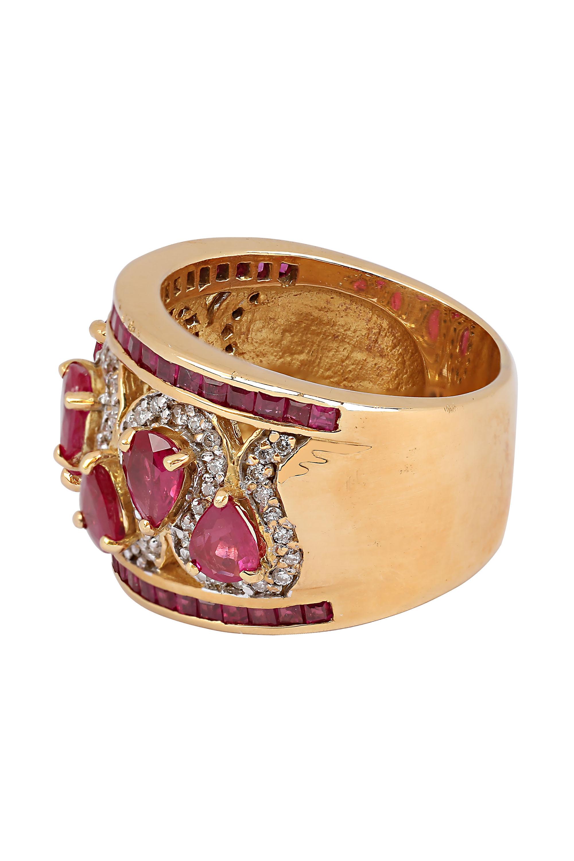 Fabricated in 18 karat yellow gold, this vintage beauty features seven alternating paisleys of bright red pear shaped rubies outlined by a sinuous framing of diamond pave. Smartly finished within a framing of square cut rubies. The pear shaped