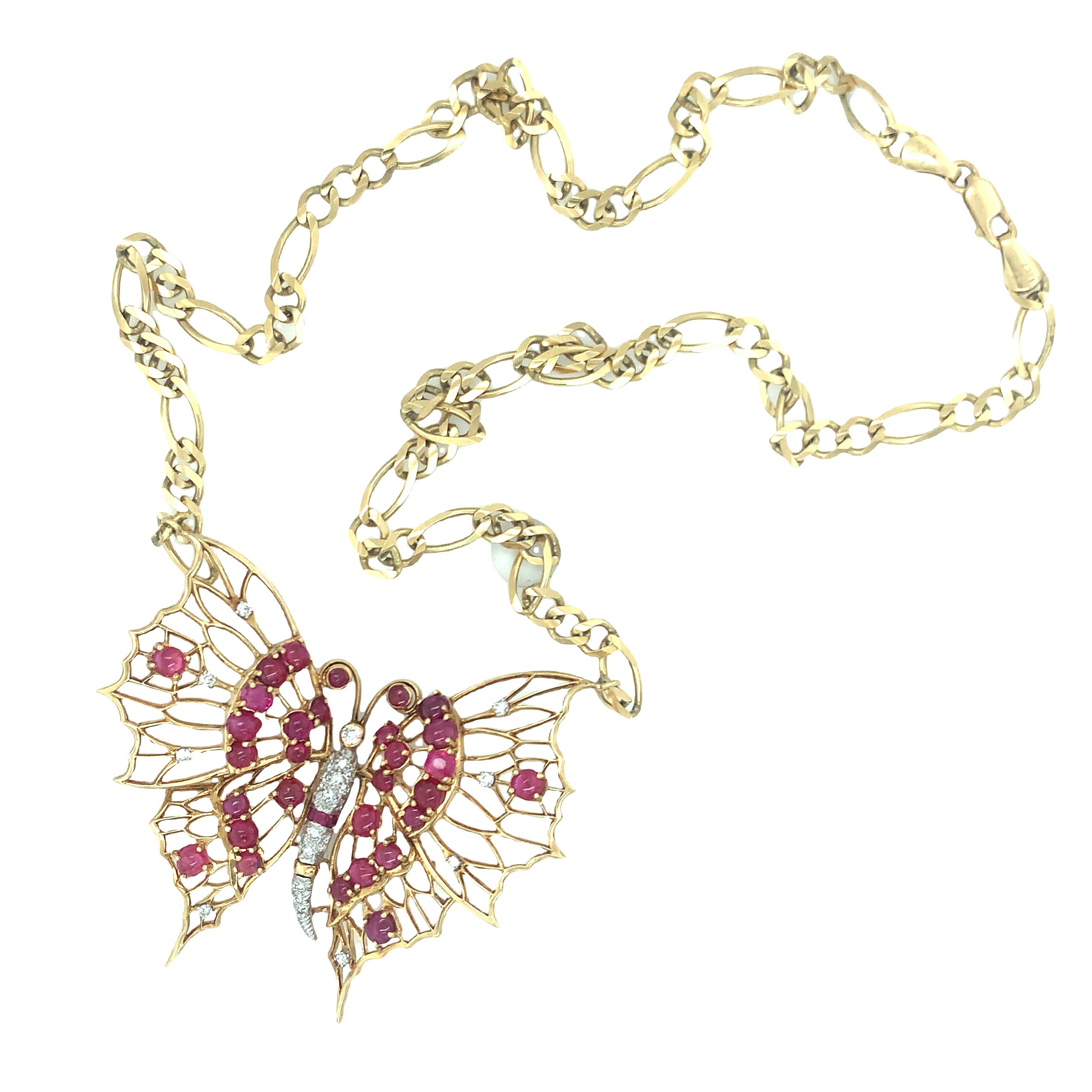 One Retro ruby and diamond butterfly motif 18K yellow gold pendant featuring 32 round cabochon and square cut rubies totaling 9 ct. Accented by 24 single round cut and old European cut diamonds totaling 0.75 ct. with a G-H color and SI-1 clarity.