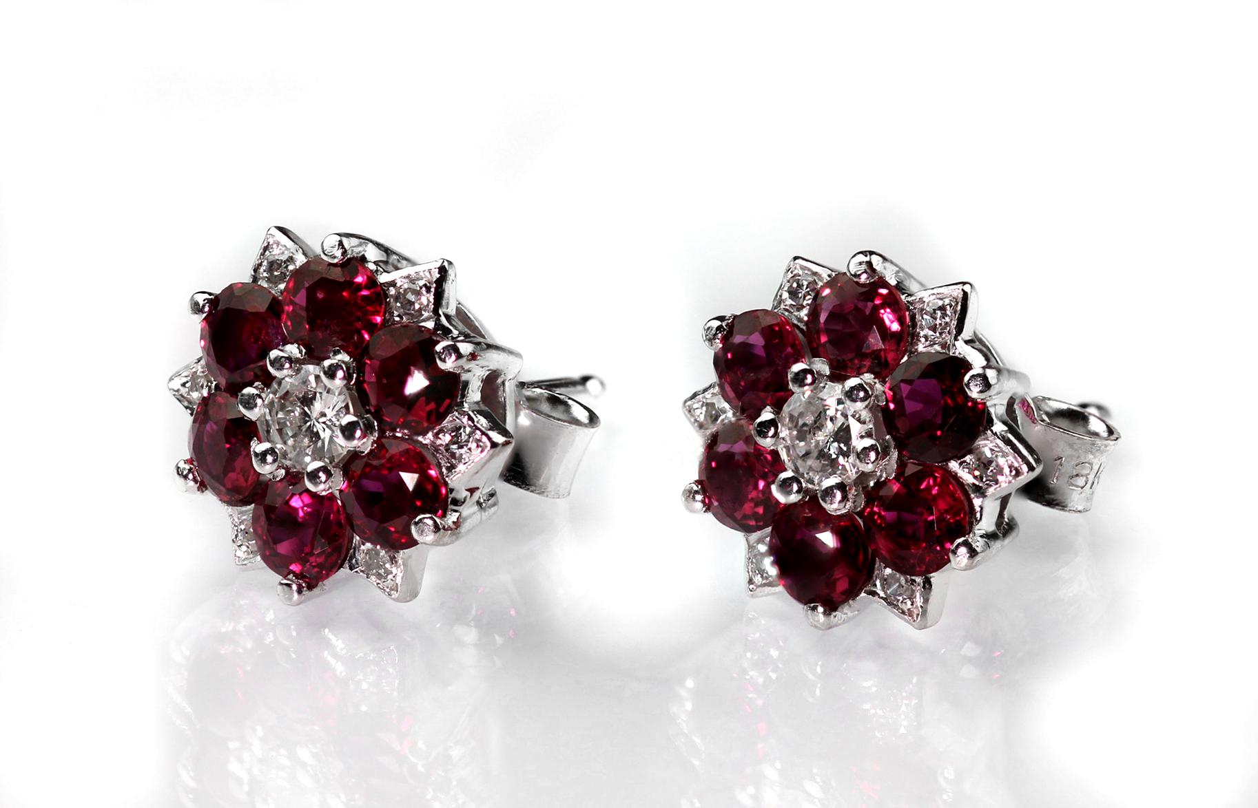 Exquisite gemstones hue of blazing ruby perfectly complement shining diamonds, pin and push on butterfly fittings. Set in 18 carat white gold hallmarked London 1975, sponsor mark not clear.
14 x round cut diamond, approximate total weight 0.20