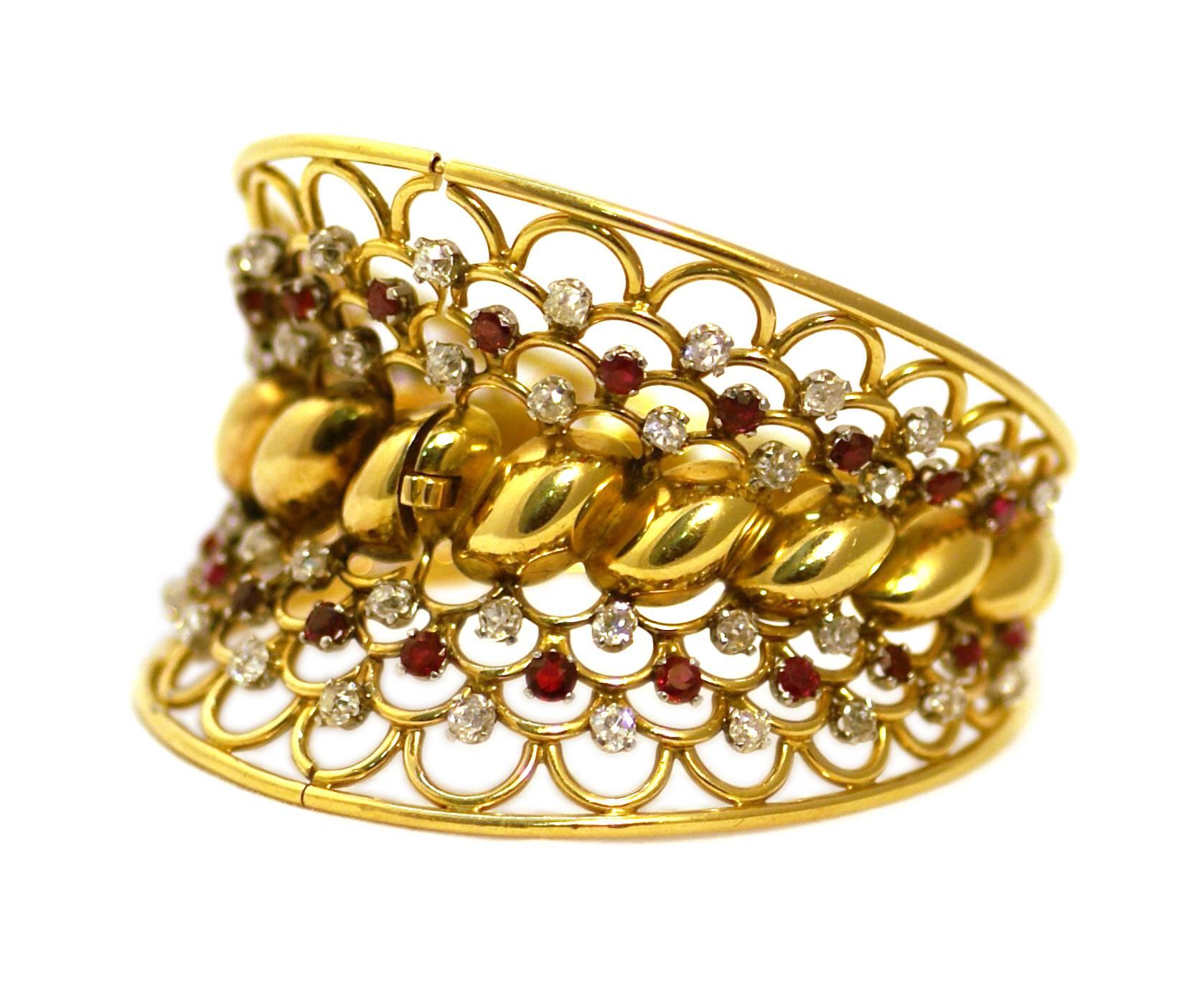 A chic Retro gold bangle, oval shaped, with rubies and diamonds. France, circa 1940. 