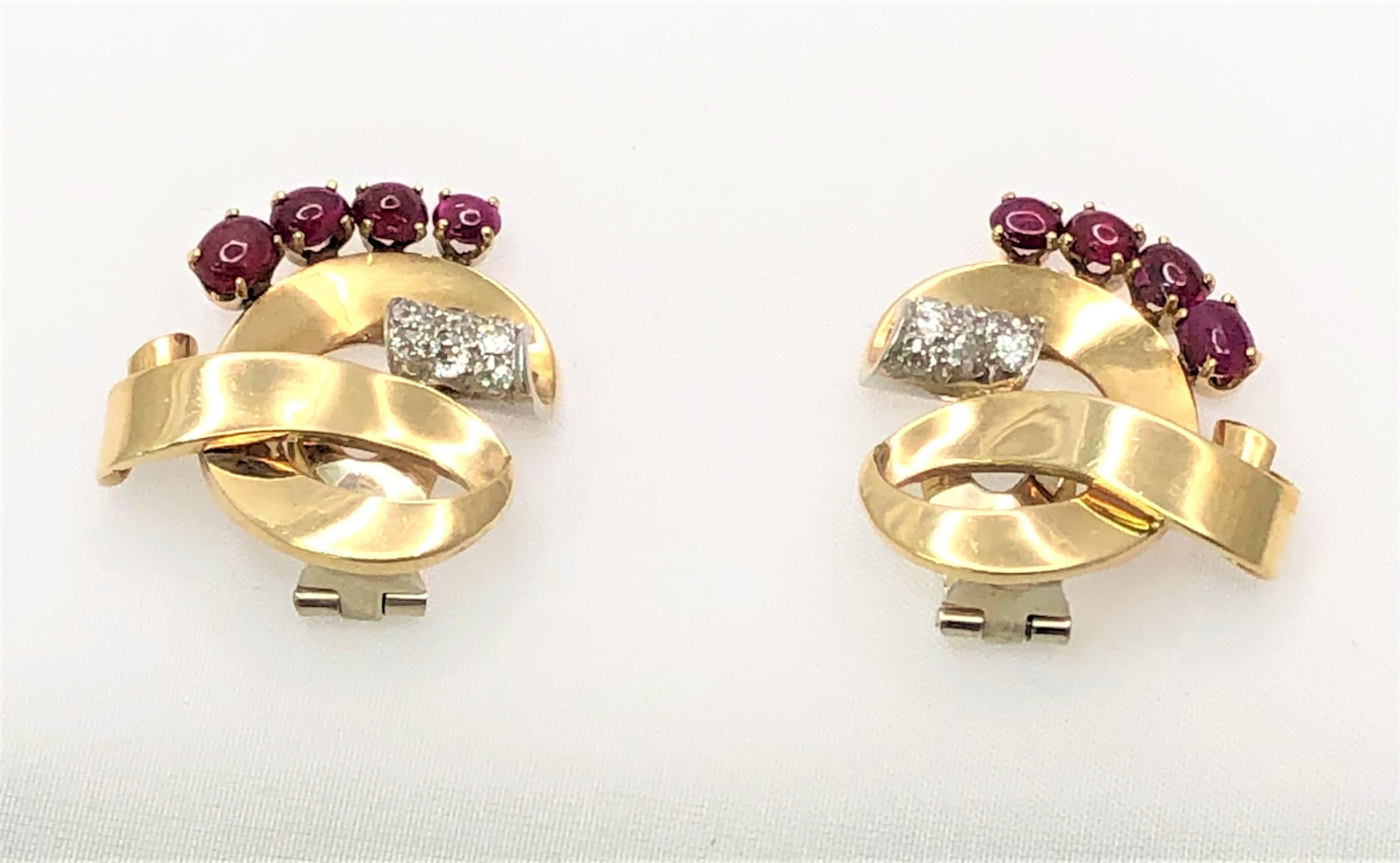 These beautiful earrings are a fun statement piece and are sure to get attention!
14 karat rose gold ribbon design.
8 cabochon rubies graduating from approximately 4x6mm to 3.5x4mm, 4 per earring.
14 round diamonds, 7 per earring, approximately .70