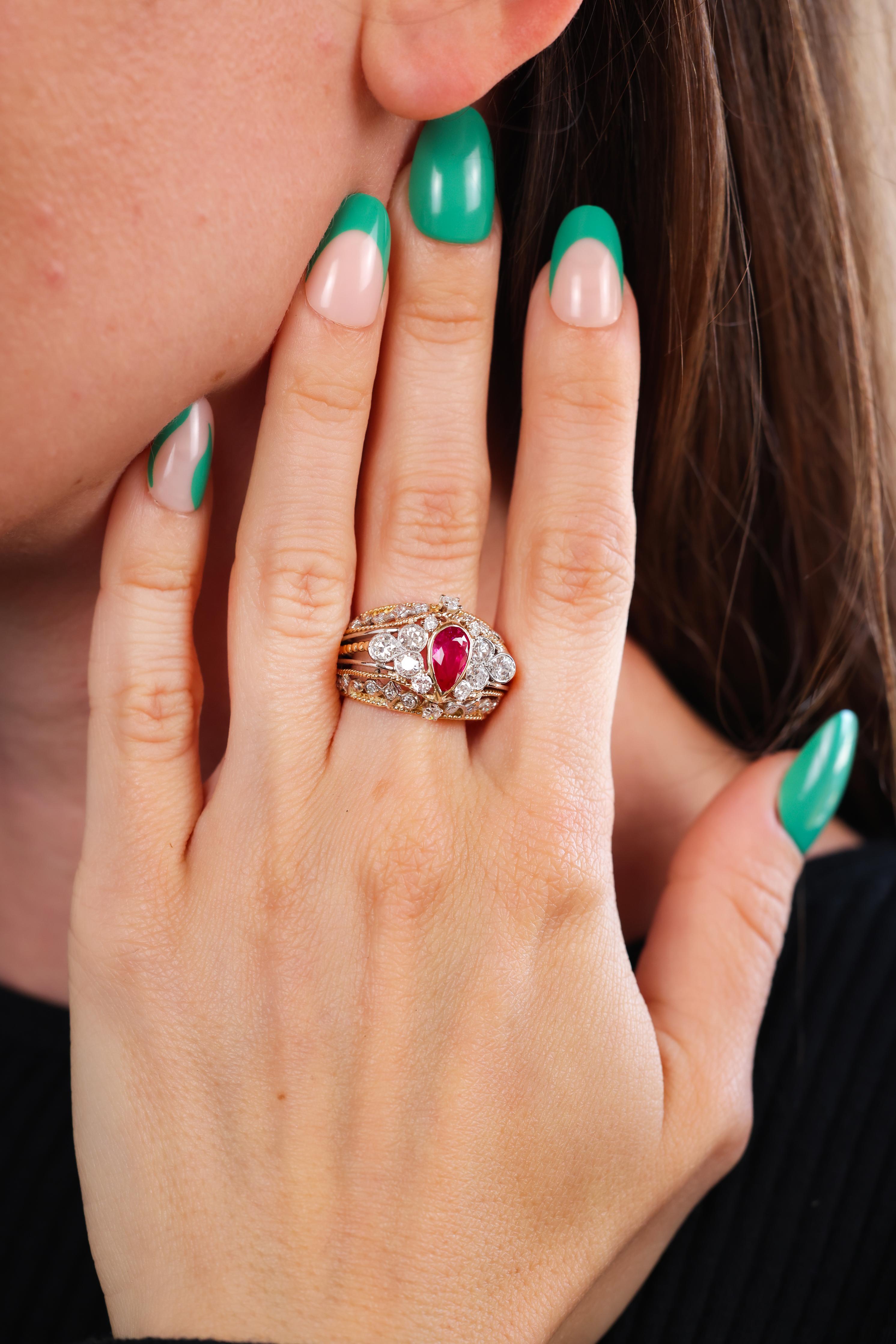 Center Stone: Ruby
Cut: Pear shape 
Weight: 1.20 carats approximately 
Accent Stone: 24 diamonds 
Cut: Old European and single
Weight: 1 carat approximately 
Color: G-H
Clarity: VS
Metal: 18k yellow gold
Era: Retro
Circa: 1940s
Size: 6-1/2 and can