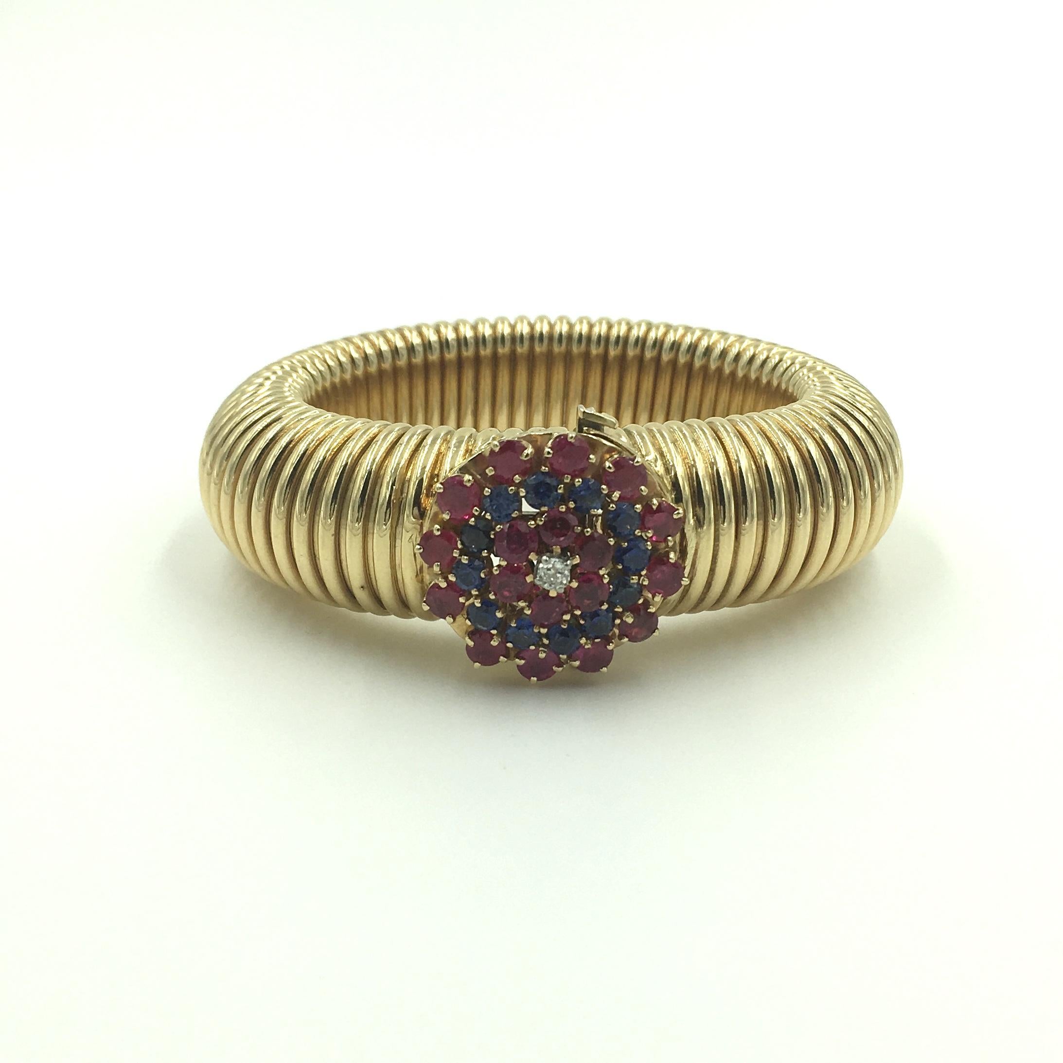14 Karat Yellow Gold 1940’s Ruby, Sapphire and Diamond Tubogas Bracelet.  The clasp set with 18 Rubies totaling approximately 3.60 Carats, 12 Sapphires totaling approximately 1.70 Carats and 1 old mine diamond weighing approximately .12 carat.  The