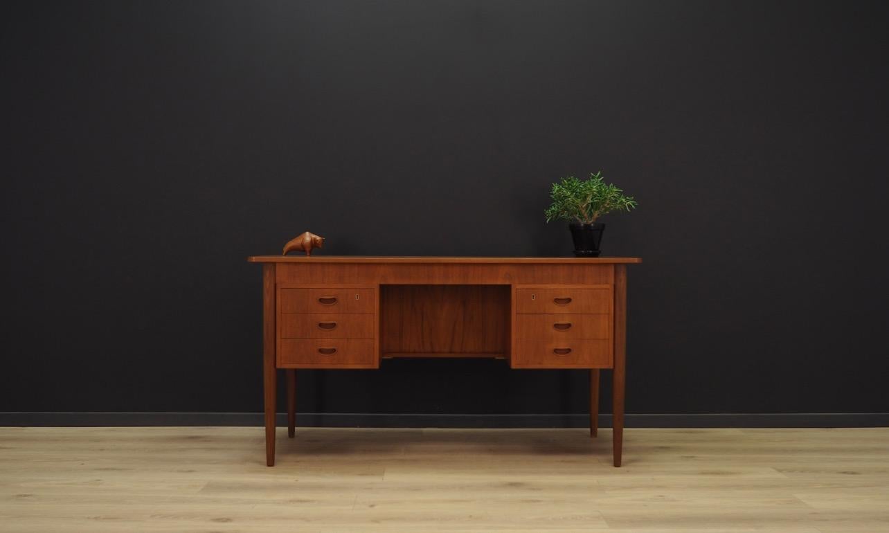 Phenomenal desk from the 1960s-1970s, Minimalist Danish design, perfect in every detail. The whole veneered with teak, handles and teak wood legs. Desk has six capacious drawers and a book shelf at the back. Preserved in good condition (small