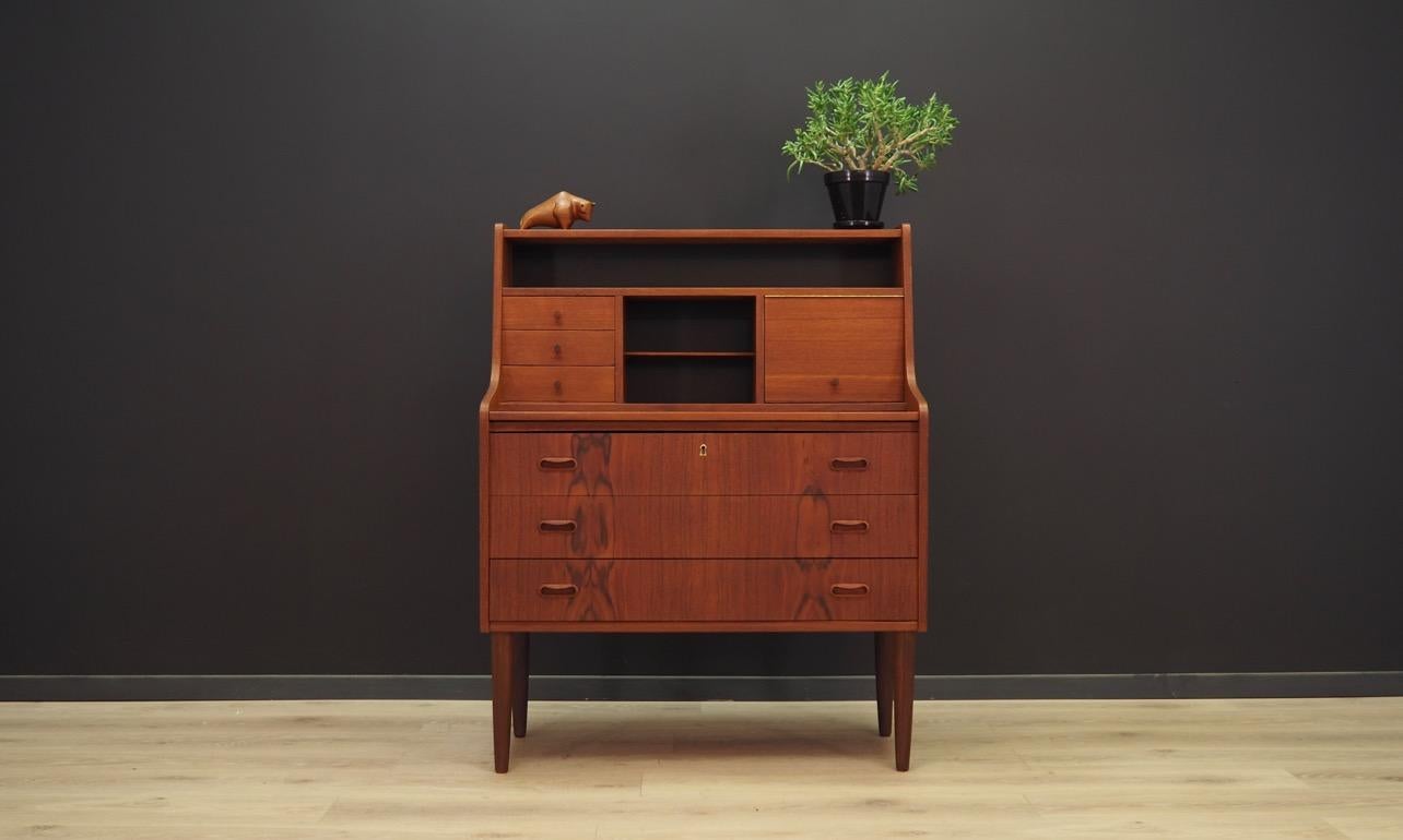 Fantastic secretaire from the 1960s-1970s . Scandinavian design, minimalist form. Furniture finished with teak veneer. The secretaire has a pull-out top and a mirror. No key included. Maintained in good condition (minor bruises and scratches, filled