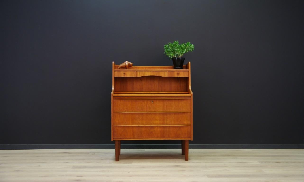 Classic secretaire from the 1960s-1970s, Danish design, surface finished with teak veneer. Item has three drawers, a mirror and a helpful sliding top. No key in the set. Preserved in good condition (small bruises and scratches) - directly for