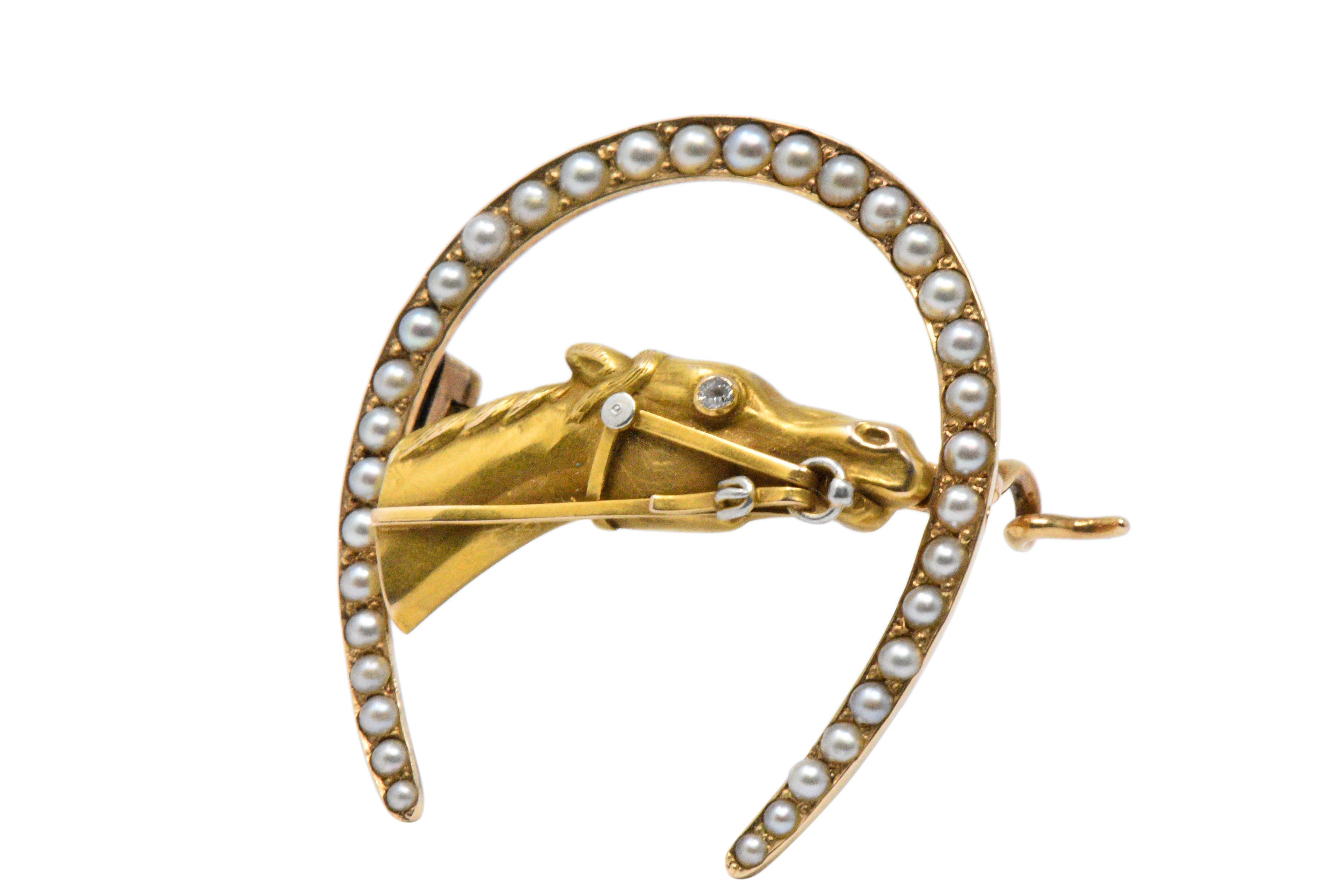 Designed as a horseshoe set with seed pearls, centering the a horse head 

Beautifully detailed horse with a single cut diamond eye, with bridle and bit

Perfect for the horse lover or equestrian  

The brooch tested to be 14K gold

Measuring: 1 1/4