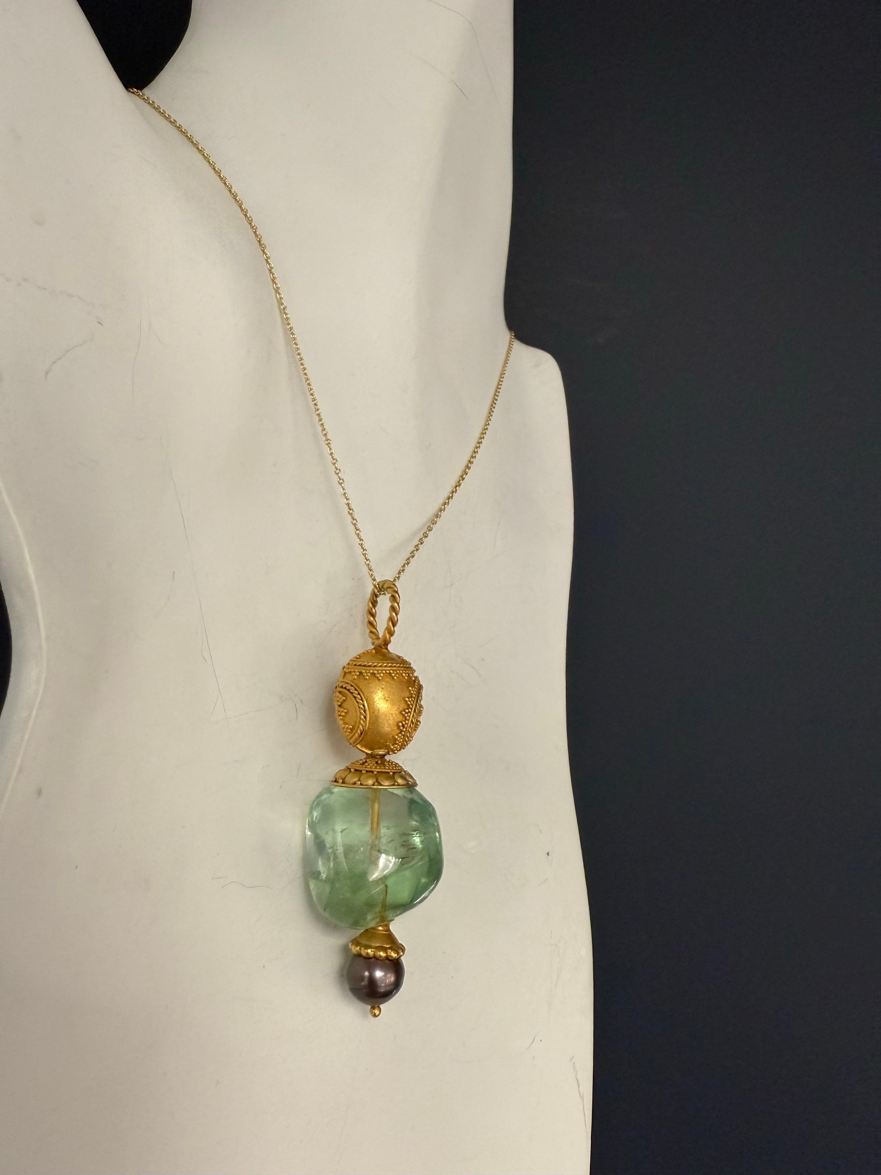 Retro silver pendant featuring a pastel green fluorite center and 9 mm black Tahitian pearl. Measuring 2.75 inches long by 20 mm wide and weighing 23.5 g. Chain not included.