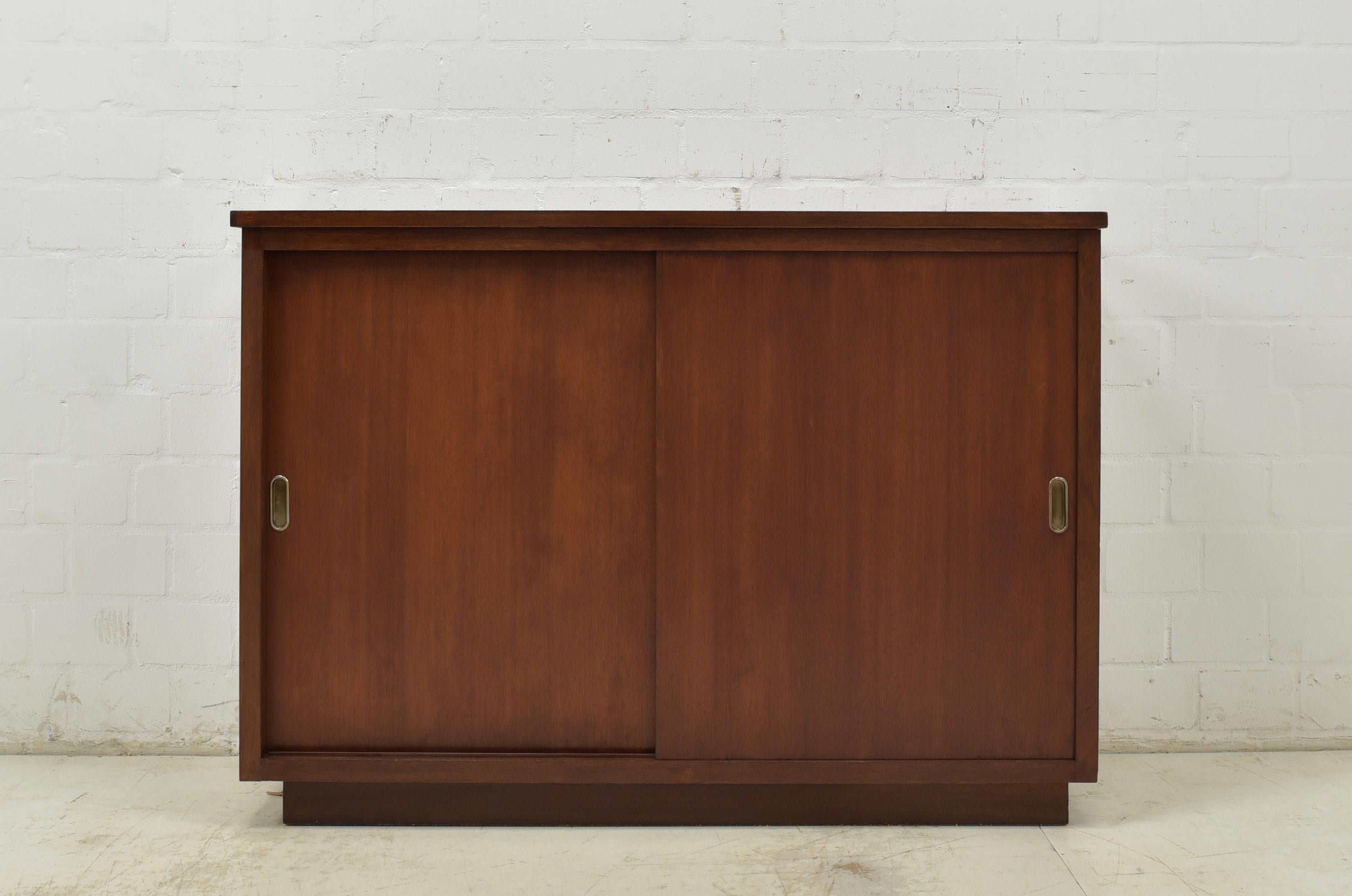 Sliding door sideboard restored circa 1950 office cabinet filing cabinet

Features:
Model with two sliding doors and two shelves
High quality
Height-adjustable solid wood shelves
Smooth sliding mechanism
Appealing, timelessly beautiful
