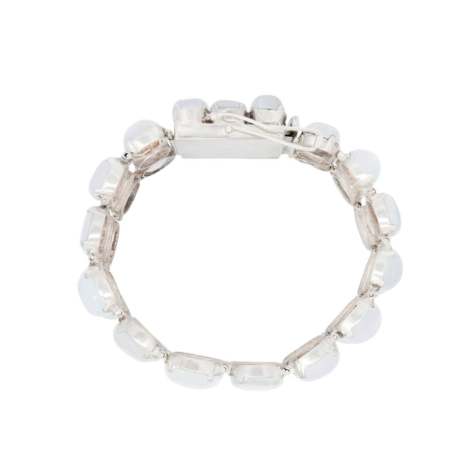 A lovely moonstone bracelet from the Vintage (ca1950s) era! Crafted in sterling silver, this beautiful piece features 48 graduating moonstone cabochons which are aligned in a triple row fashion extending the length of the piece. Each cabochon is set