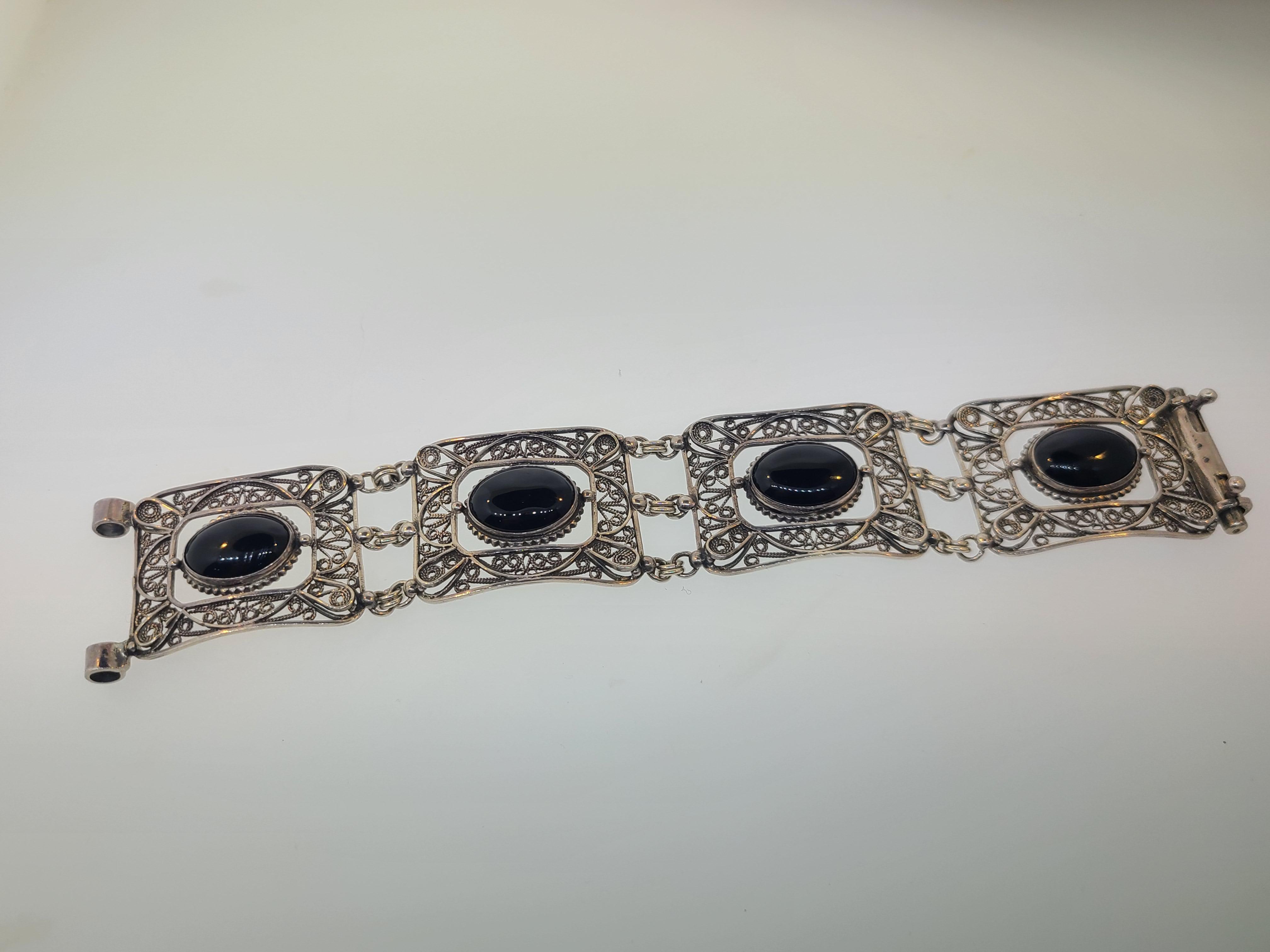 This estate found retro 1960's/70's linked panel bracelet is made of sterling silver with oval cut cabochon stones. The bracelet measures 7 3/4