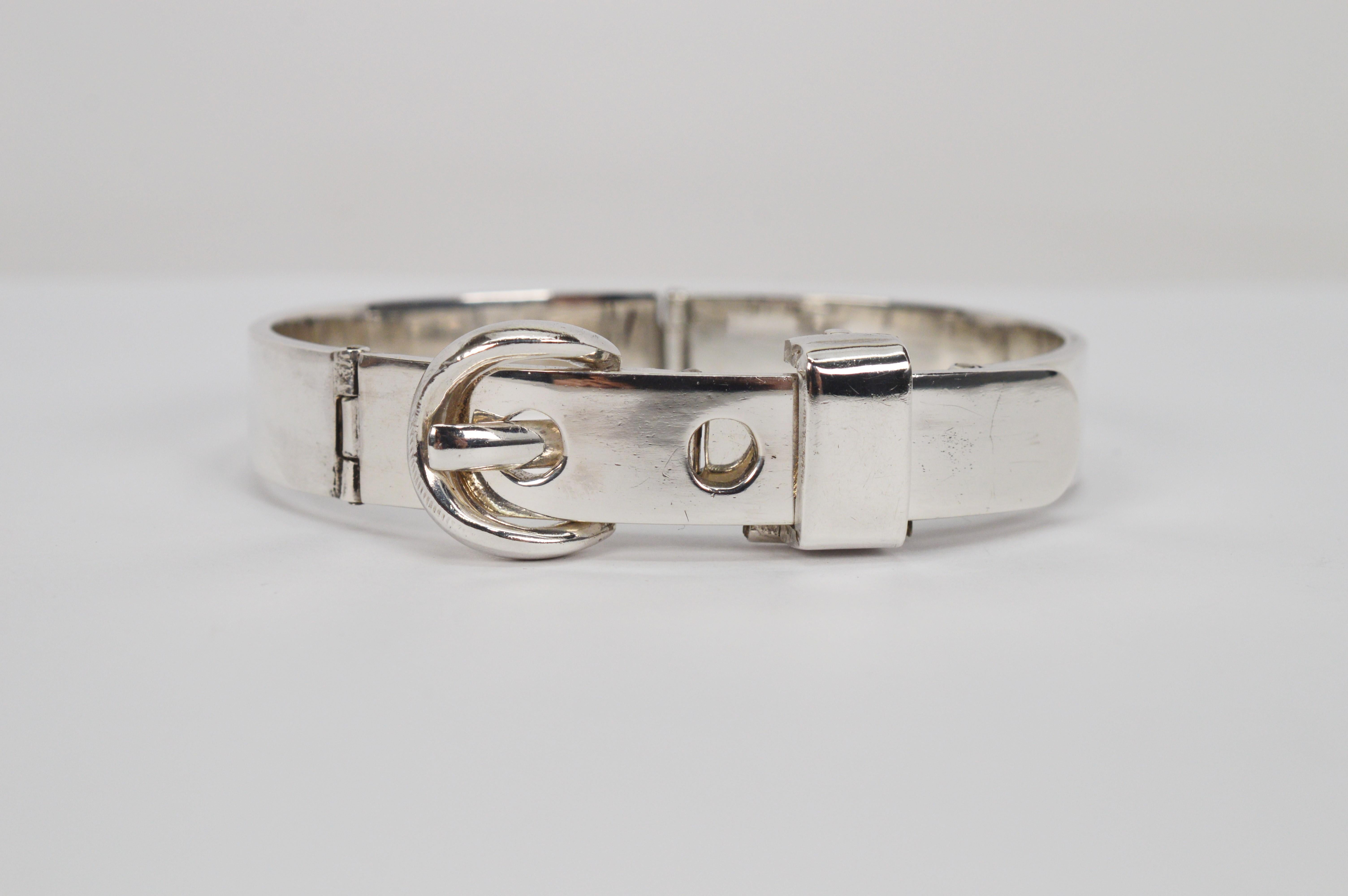 Uniquely designed with a working buckle all in .925 sterling silver. This unusual bracelet is a fabulous retro piece to add to any silver lovers collection. This interesting cuff in heavy gauge sterling is constructed with four moving hinged