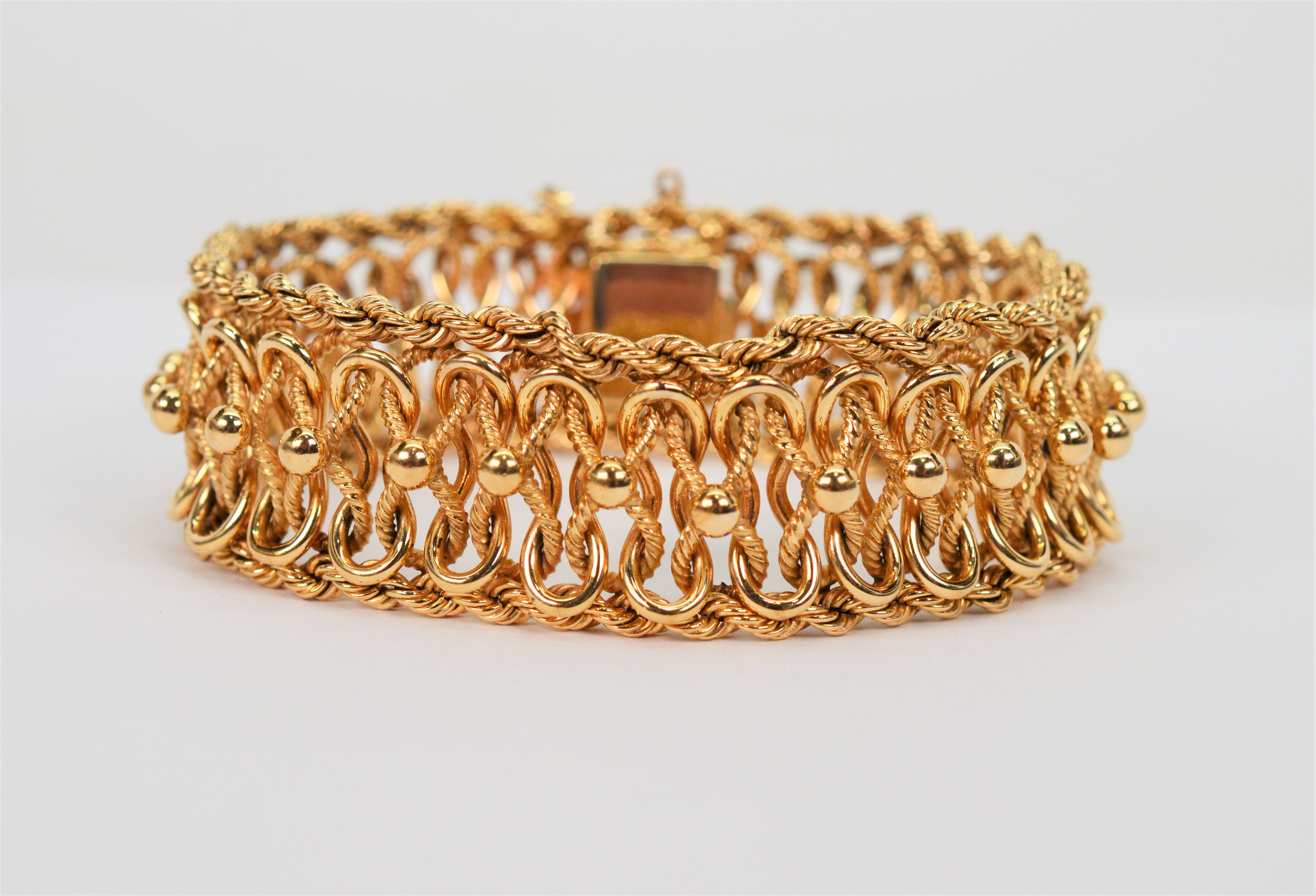 The fabulous workmanship of this quality 1950's Retro style bracelet is displayed by the intricate design of the custom woven 14 karat yellow gold links that are meticulously framed with gold roping. Wildly popular mid- century, this retro style
