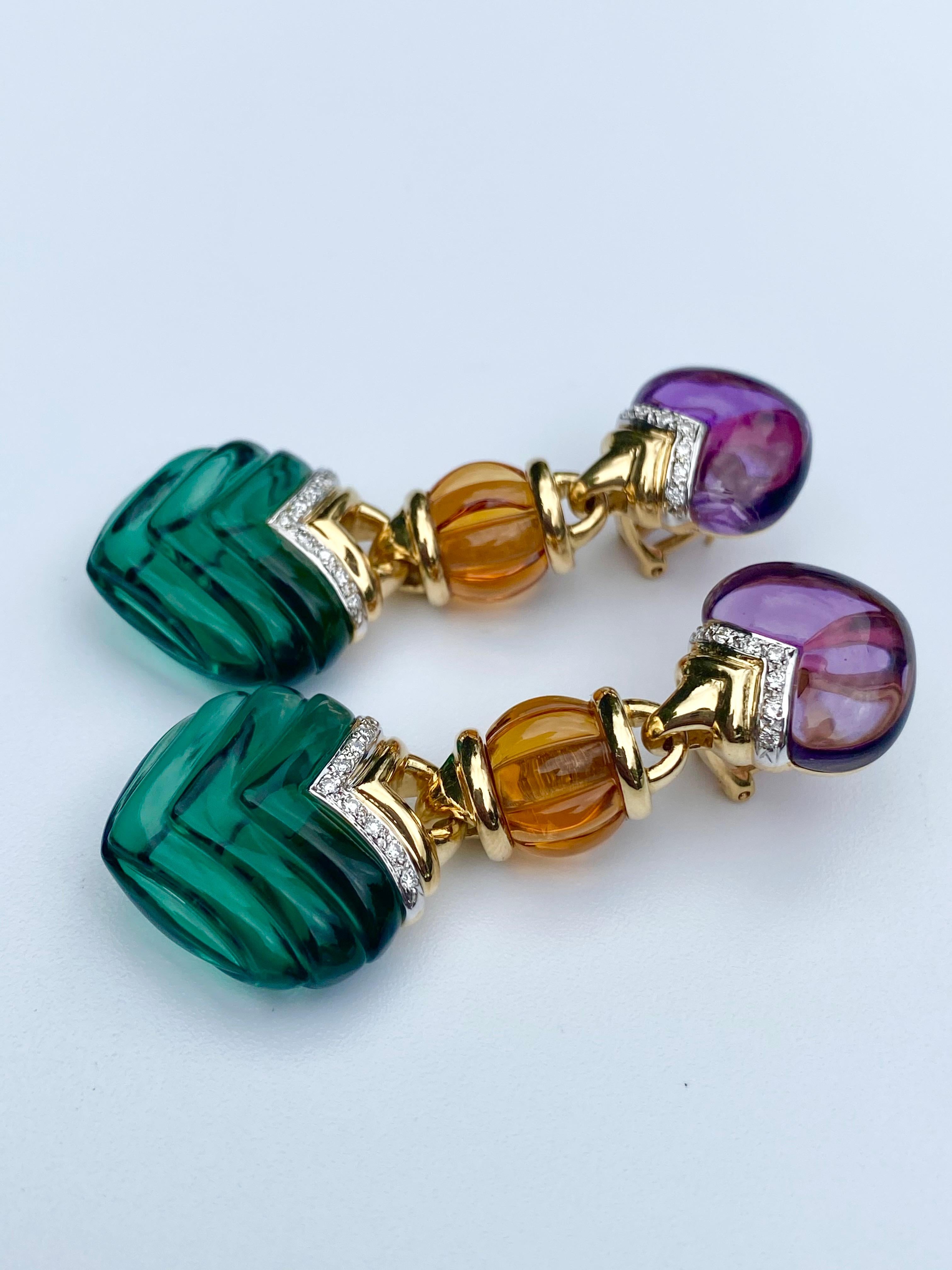 Adorned by lovely carved Green Quartz, Amethyst, and Citrine, these Retro-Style earrings are a true statement piece! Accented by 0.40 Carats of Round-Brilliant Diamonds and set in 18K White and Yellow Gold. 

Details:
✔ Stone: Amethyst, Citrine,