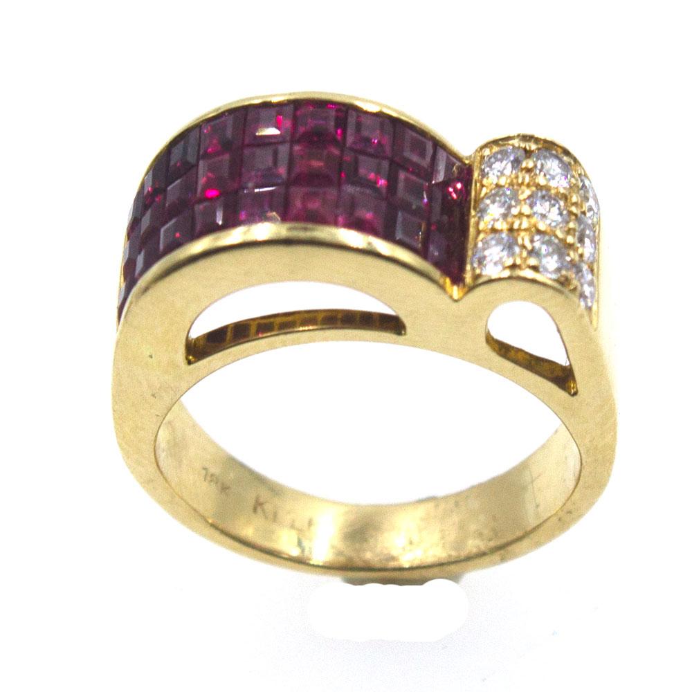 Invisibly set princess cut rubies and round brilliant cut diamonds are set in 18 karat yellow gold. This retro style ring measures 8.5mm in width and is currently size 6. There are approximately .50 carat total weight of diamonds. 