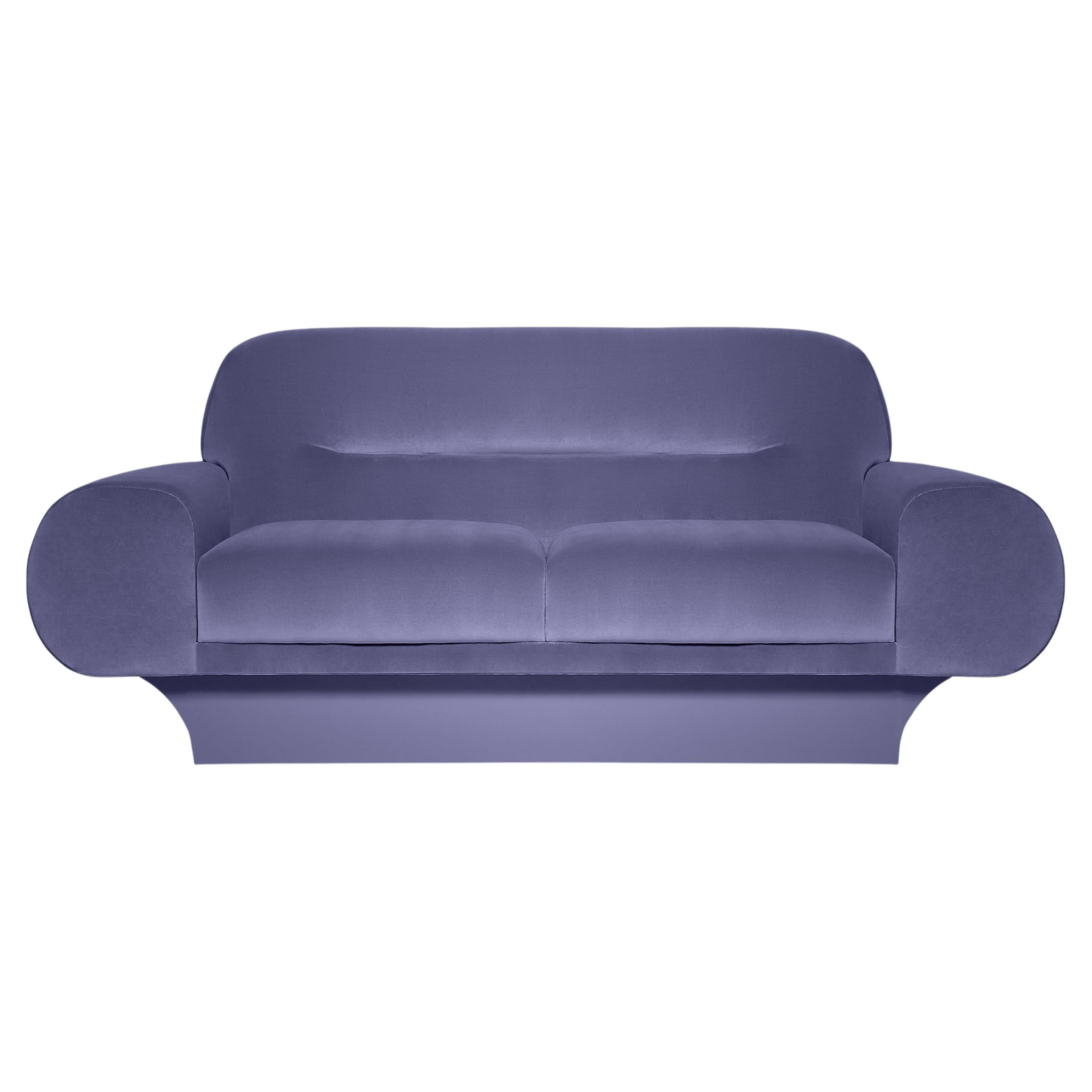 This sofa has an impactful Silhouette. The oversized softly curved arms and back work in either formal and more casual settings, it has relaxed comfort in mind. It’s grand, curvy and charismatic.
Upholstery: High Resistance Velvet 
Footer: Lacquer