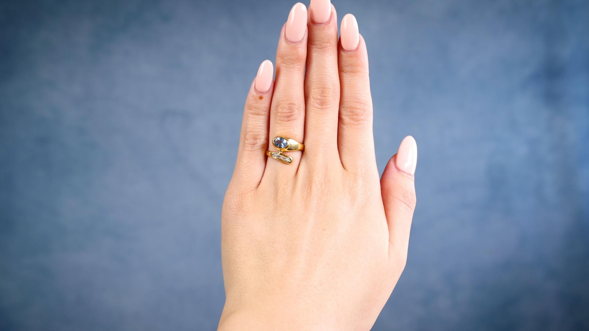 One Retro Synthetic Spinel 18k Yellow Gold Ring. Featuring one oval brilliant cut synthetic spinel weighing approximately 0.80 carat. Accented by one single and three old European cut diamonds with a total weight of approximately 0.15 carat, graded