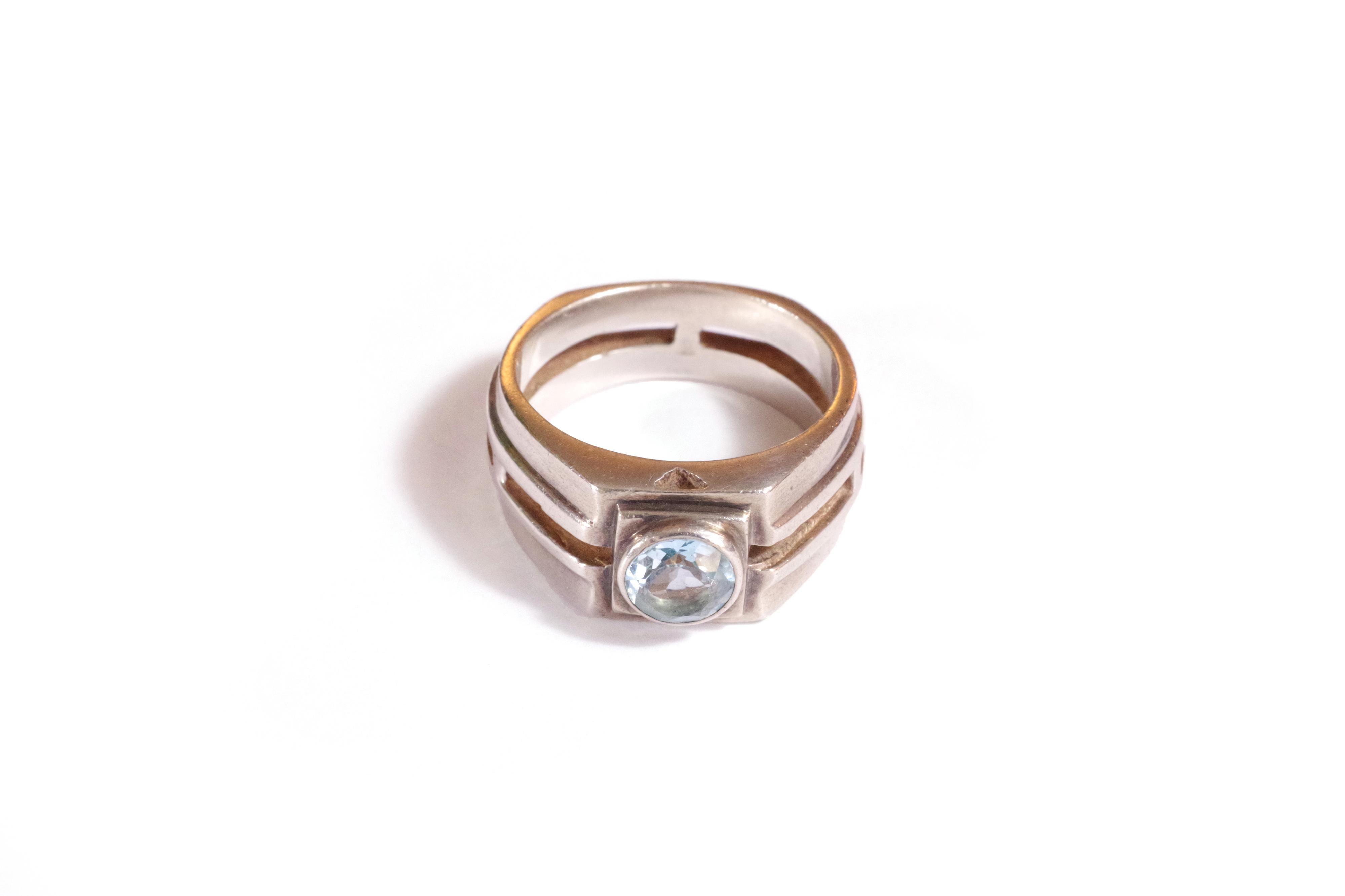 Retro Tank Topaz Ring made of silver with a bezel-set topaz of blue color in the center of the ring with geometric lines. The ring is also worked in openwork. Foreign work, end of the Retro period.

Partially erased silver hallmark, 925 hallmark, SM