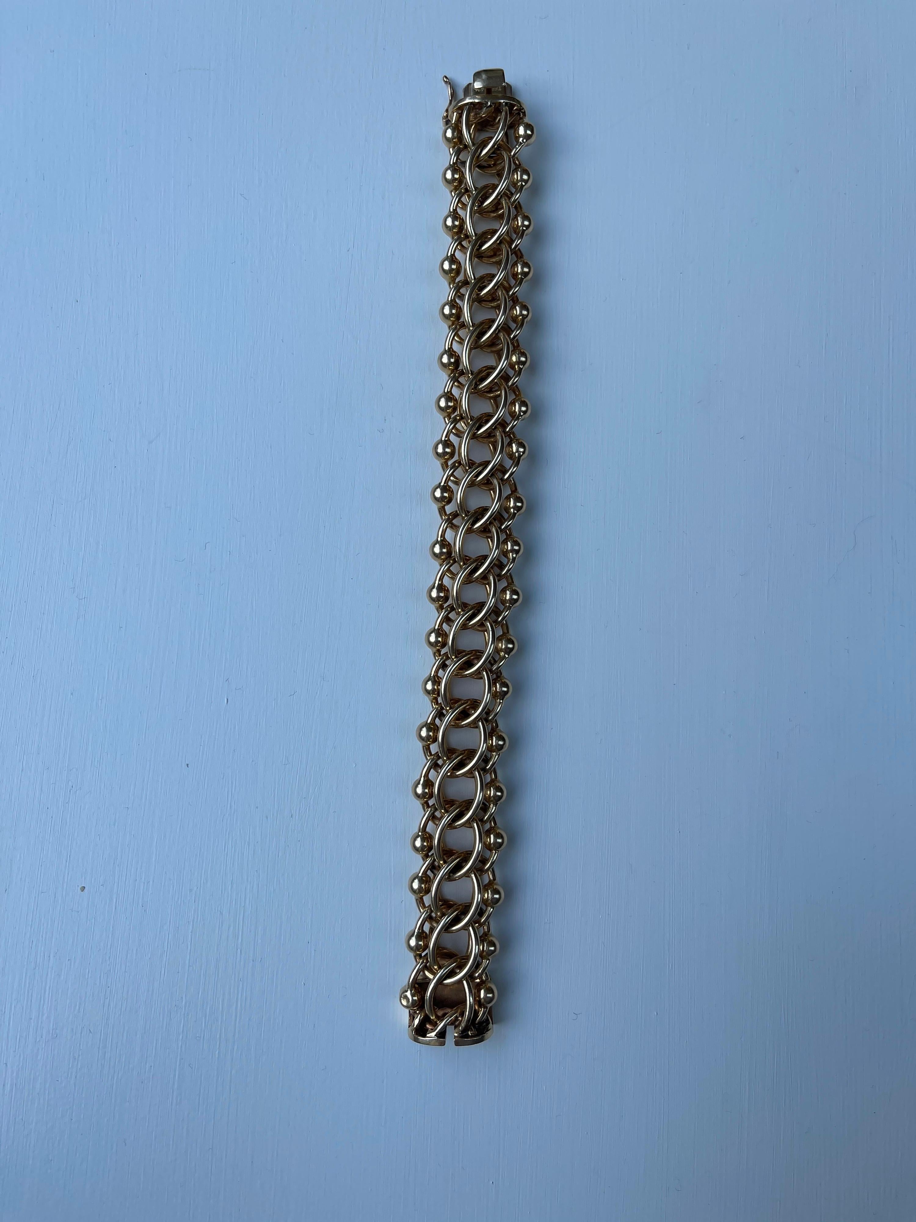 A very stylish 14 kt yellow gold bracelet by Tiffany and Co. The bracelet is signed on the tongue and also stamped D F S. The bracelet weighs 110 grams 