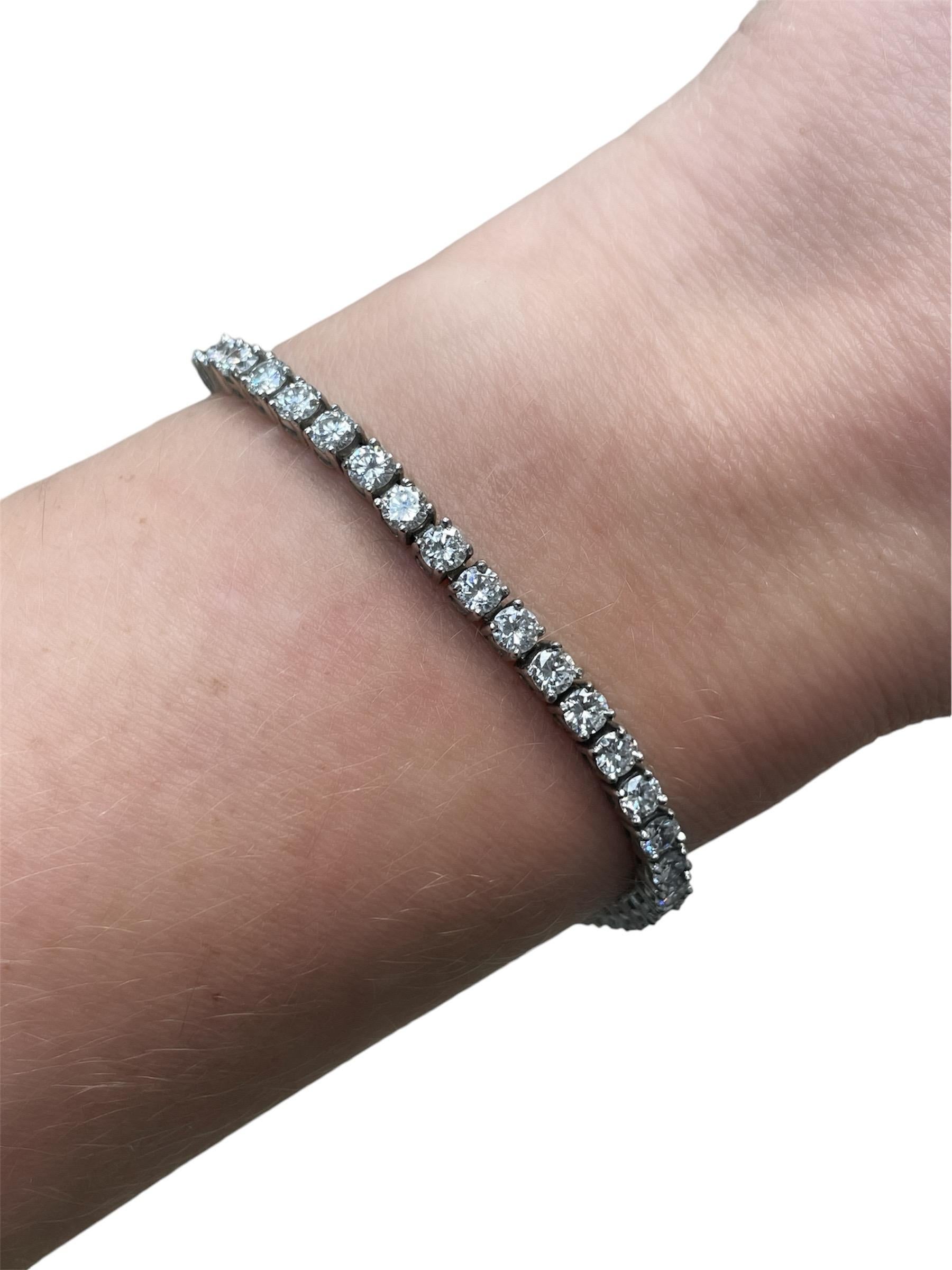 This absolutely unique bracelet by Tiffany & Co. circa 1940's is two bracelets in one! Consisting of a skillfully crafted jacket with snake chain and three folding diamond stations holding a removable diamond tennis bracelet. The jacket containing