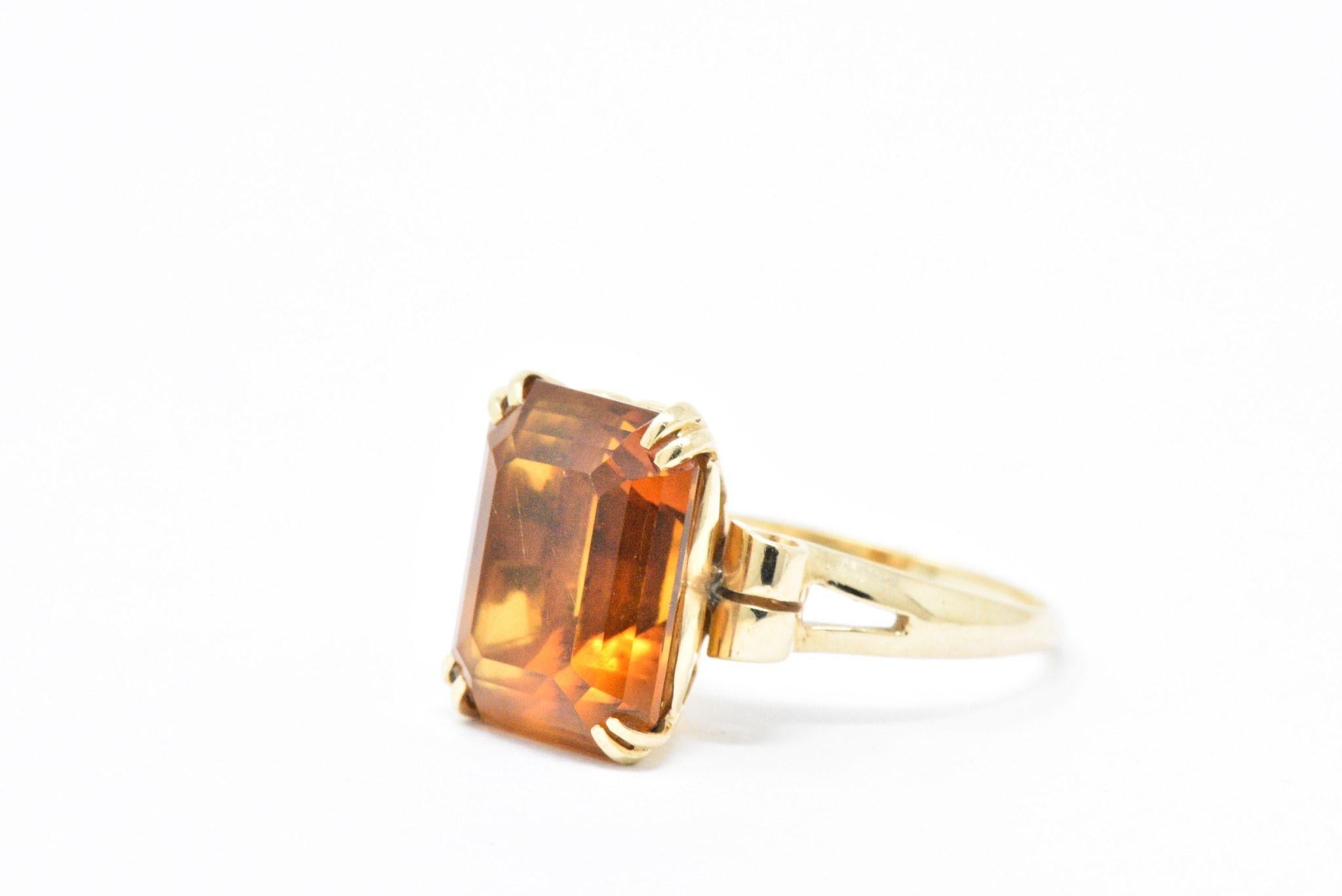  Centering a rectangular step cut citrine weighing 7.25cts, deep rich orange color

In a simple but elegant 