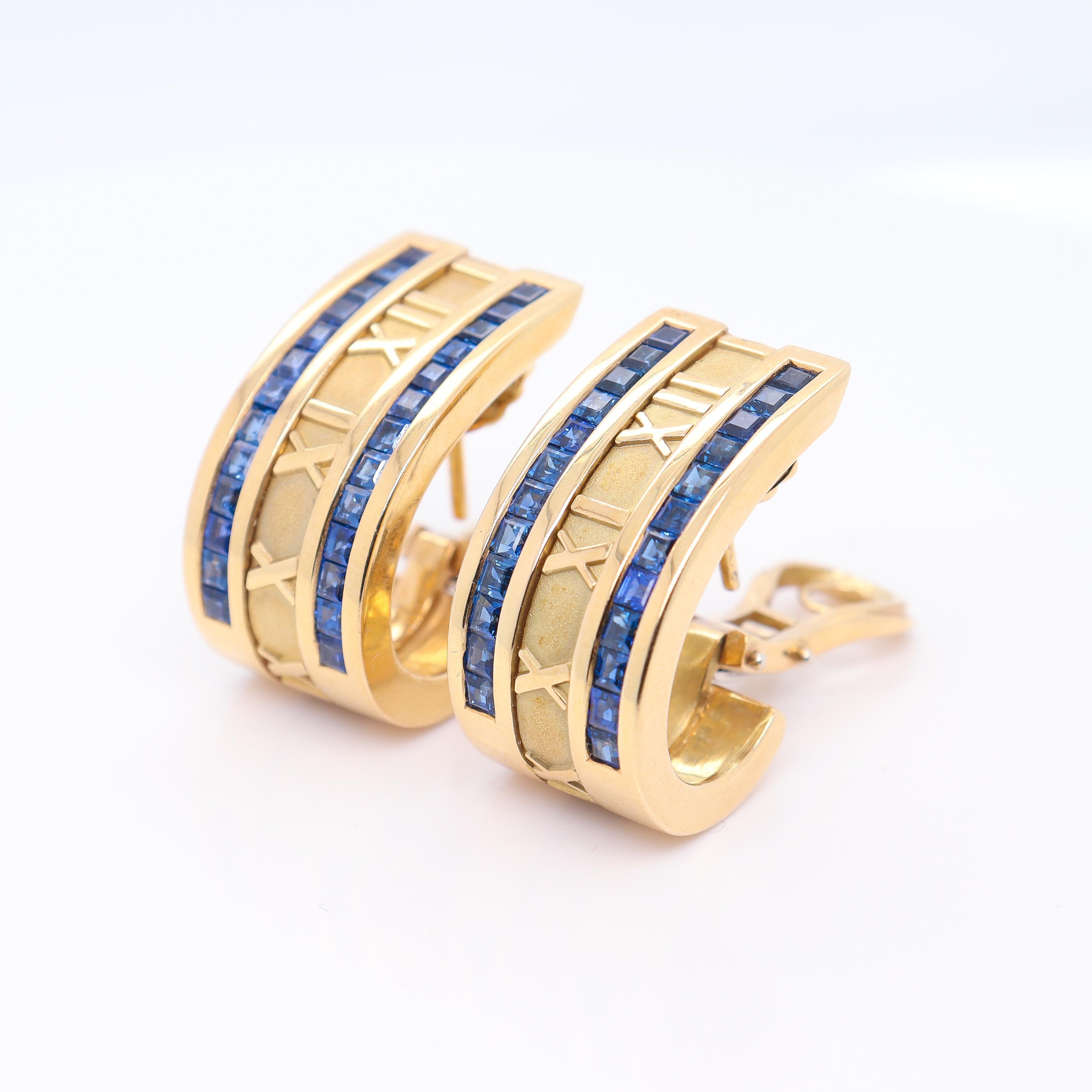 A fine pair of retro Tiffany & Co. gold & sapphire clip earrings.

In 18K gold.

In the Atlas pattern.

Each channel set with 24 square cut sapphires and omega clip backs for extra security.

The 'Atlas' collection was designed by John Loring in the