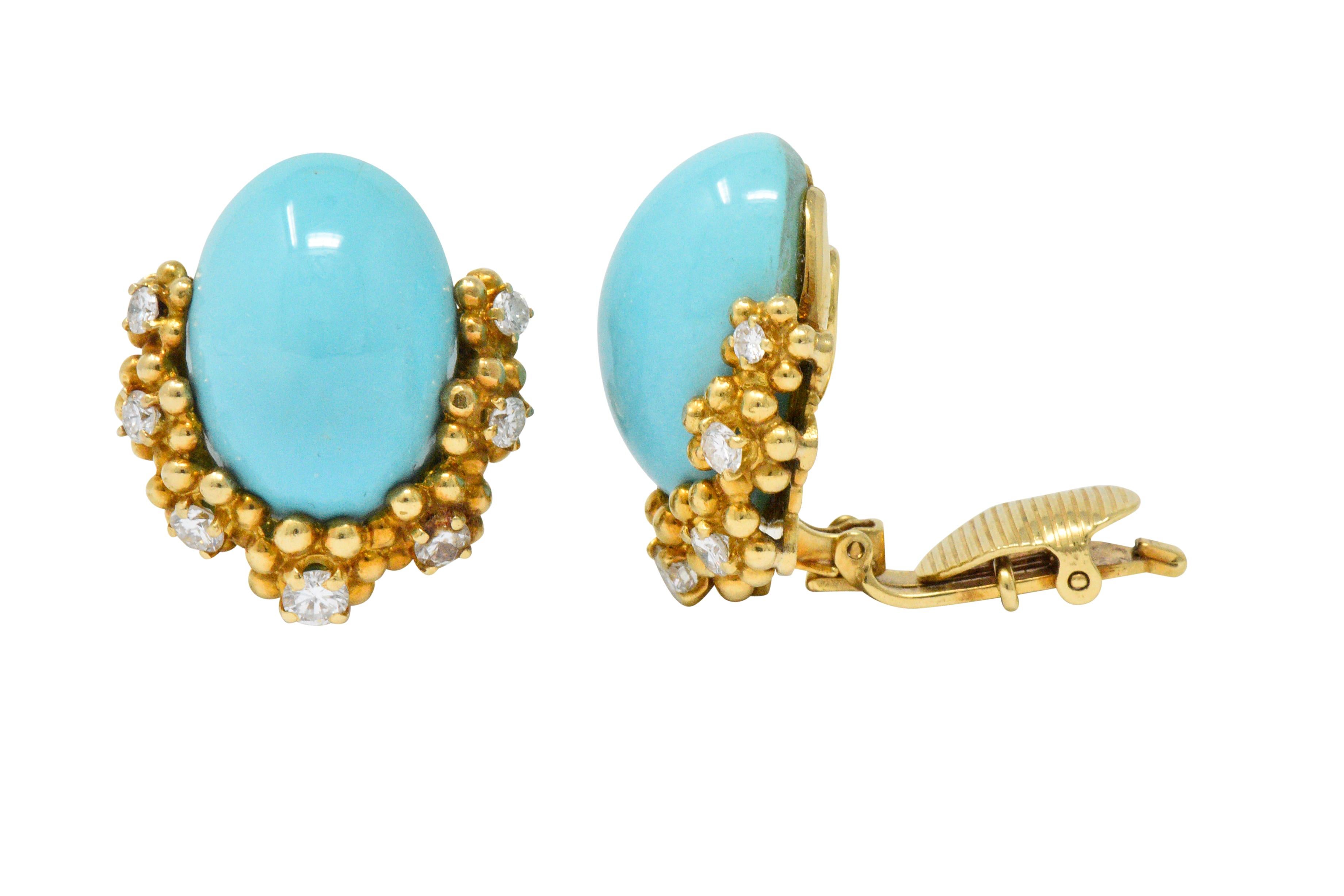 Each with oval turquoise cabochon, measuring approximately 19.3 x 13.5 mm, bright robin's egg blue, very well matched and very good luster

Accented by 7 round brilliant cut diamonds each, in gold bead 