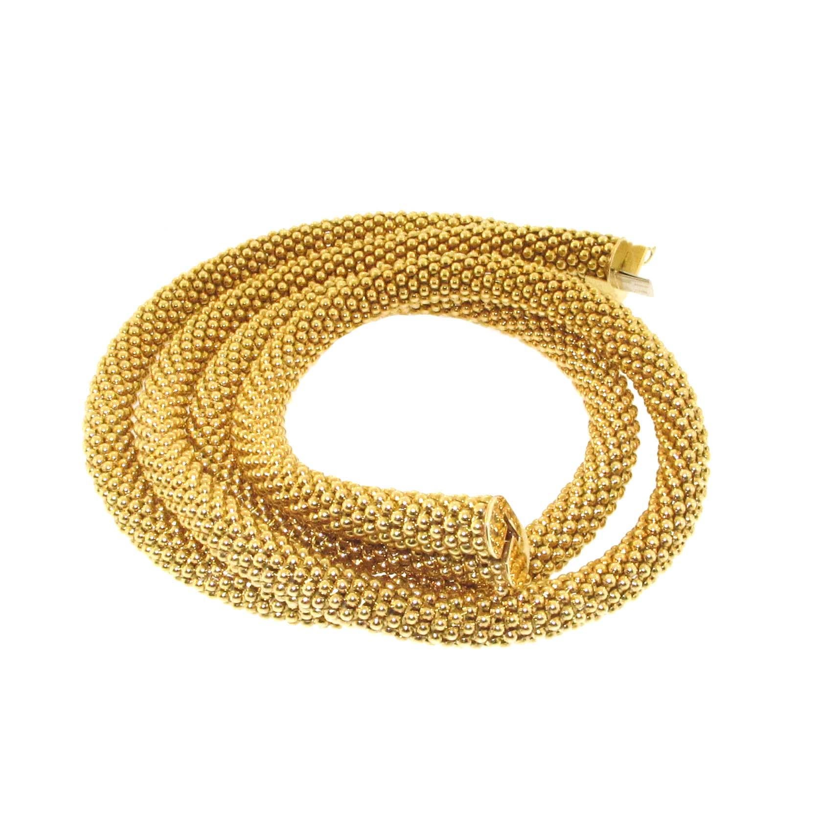 This necklace screams Tiffany! They are one of the finest manufacturers in the world when it comes to 18kt yellow gold necklaces. This necklace is a double wrap which clasps behind the neck together in the back. It has a gorgeous beaded texture and