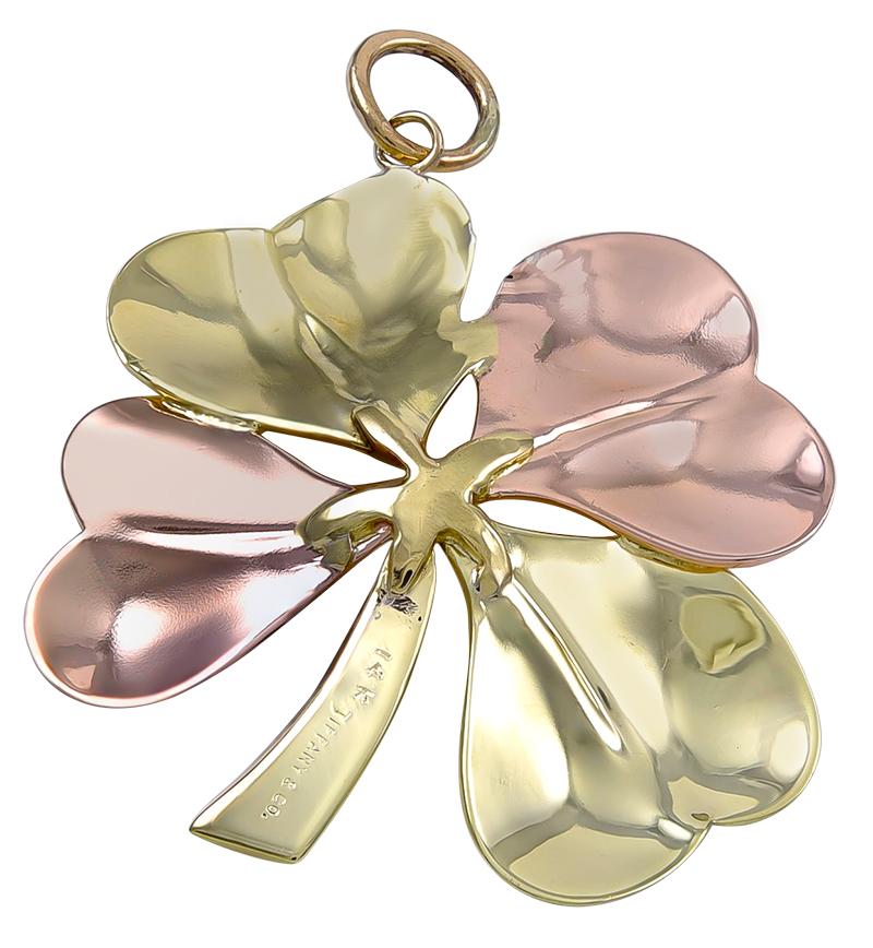 Graceful figural four-leaf clover pendant/charm.  Made and signed by TIFFANY & CO.  14K rose and yellow gold.  1 1/3
