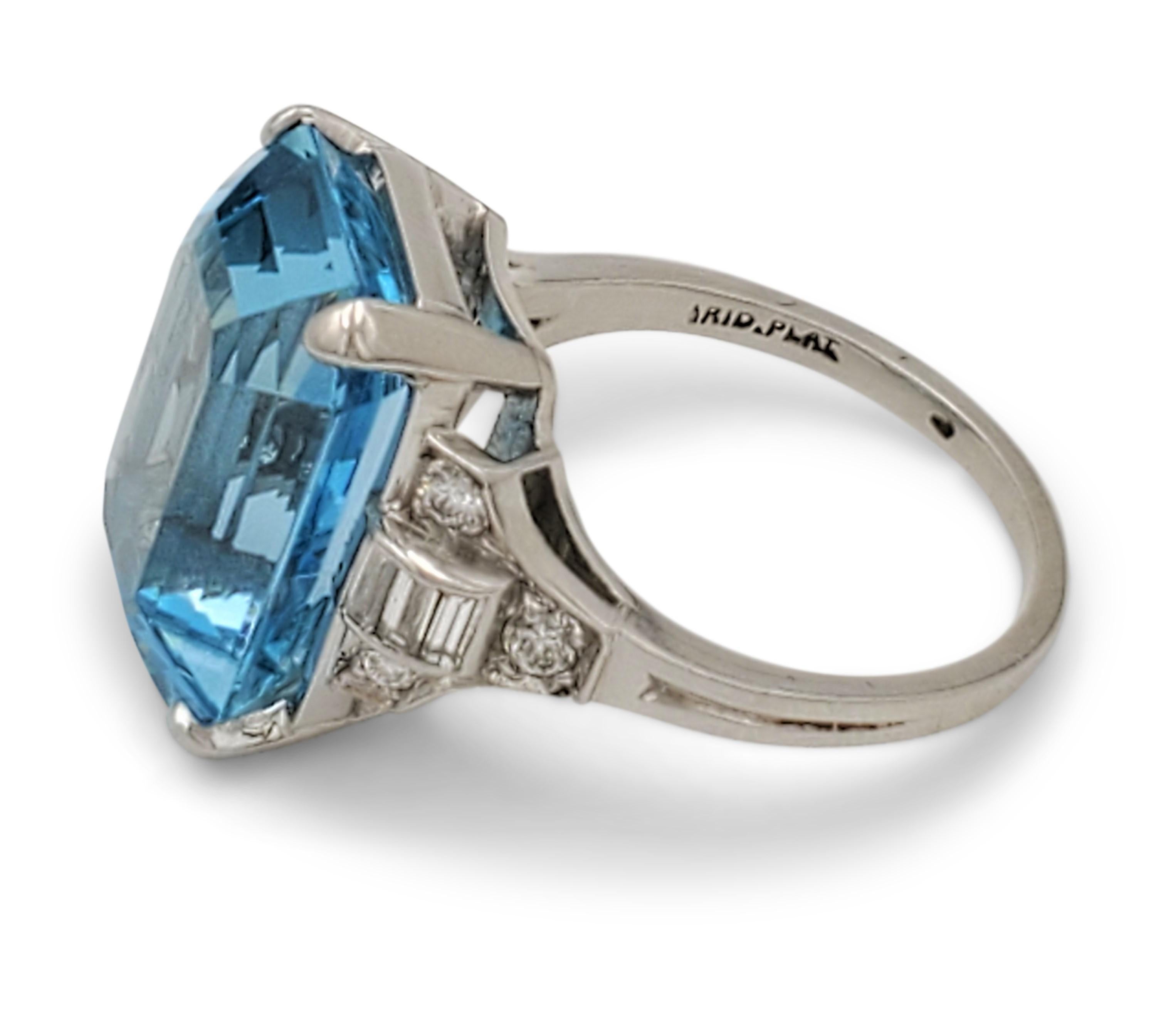 Charming Retro Tiffany & Co. aquamarine cocktail ring crafted in platinum. The aquamarine stone measures an estimated 9.10 carats (15.5 mm x 11.6 mm x 7.4 mm) and is flanked by round and baguette-cut diamonds of high quality weighing approximately