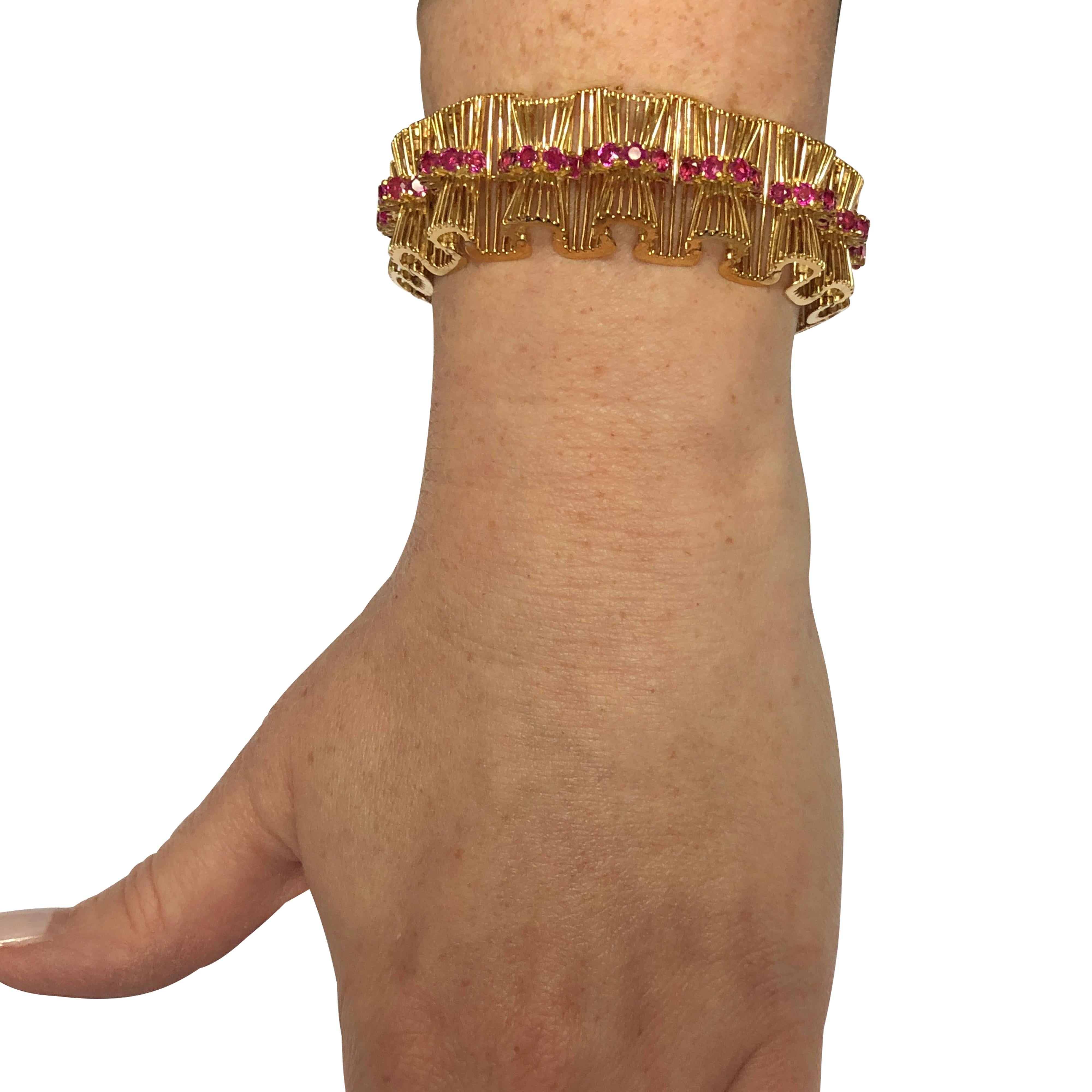 Spectacular Tiffany and Co. retro bracelet, crafted in 18 karat yellow gold, featuring 70 round cut Burma rubies weighing approximately 8 carats total. This stunning bracelet resembles a ruffled ribbon, laced with Burma ruby detail, creating a