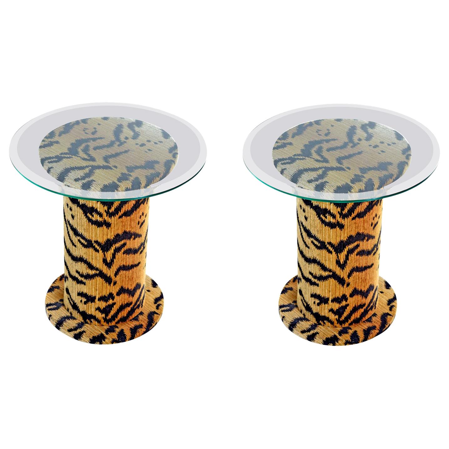 Fun, funky, wild, one of a kind set of pedestals. These surprisingly hefty tables are covered in tiger fabric top to bottom. As bold as they are versatile. Beveled glass tops are in excellent condition. These are unmarked and we're guessing the