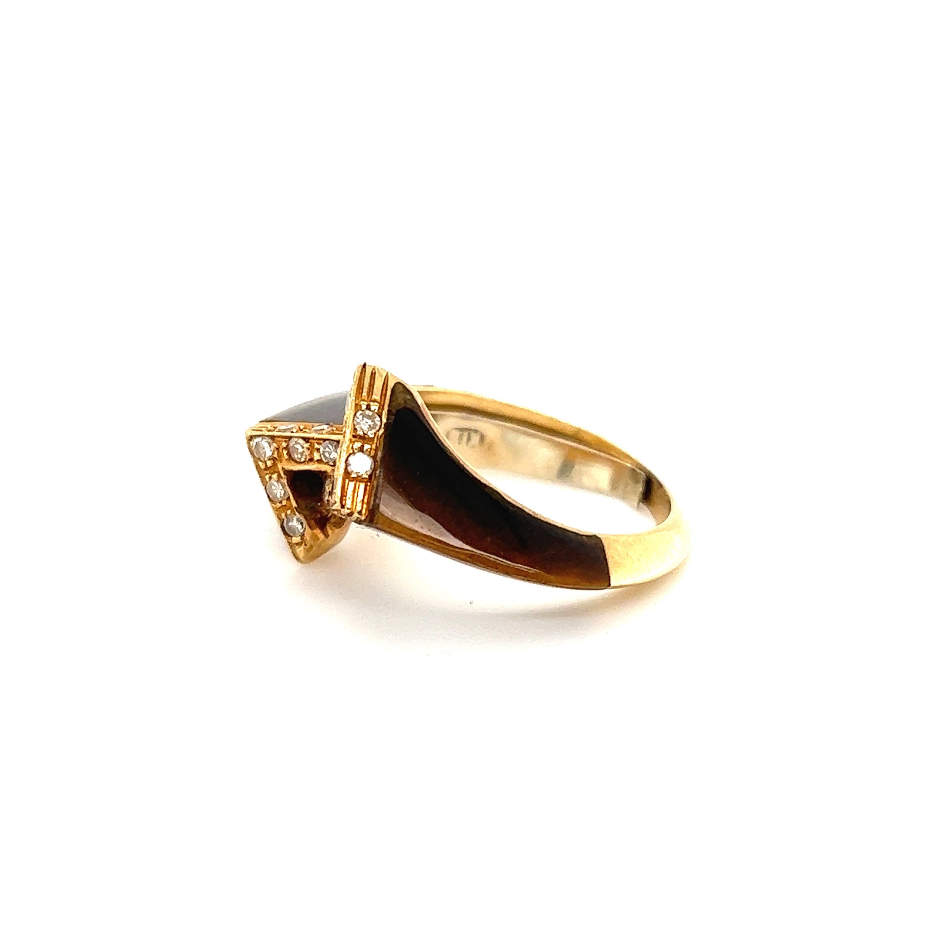 Fantastic design seen on this retro gemstone and diamond ring. The fantastic ring is unique and eye catching as I have personally never seen one like it! The ring is crafted in 18k yellow gold and shows a sharp knife edge design in the tigers eye