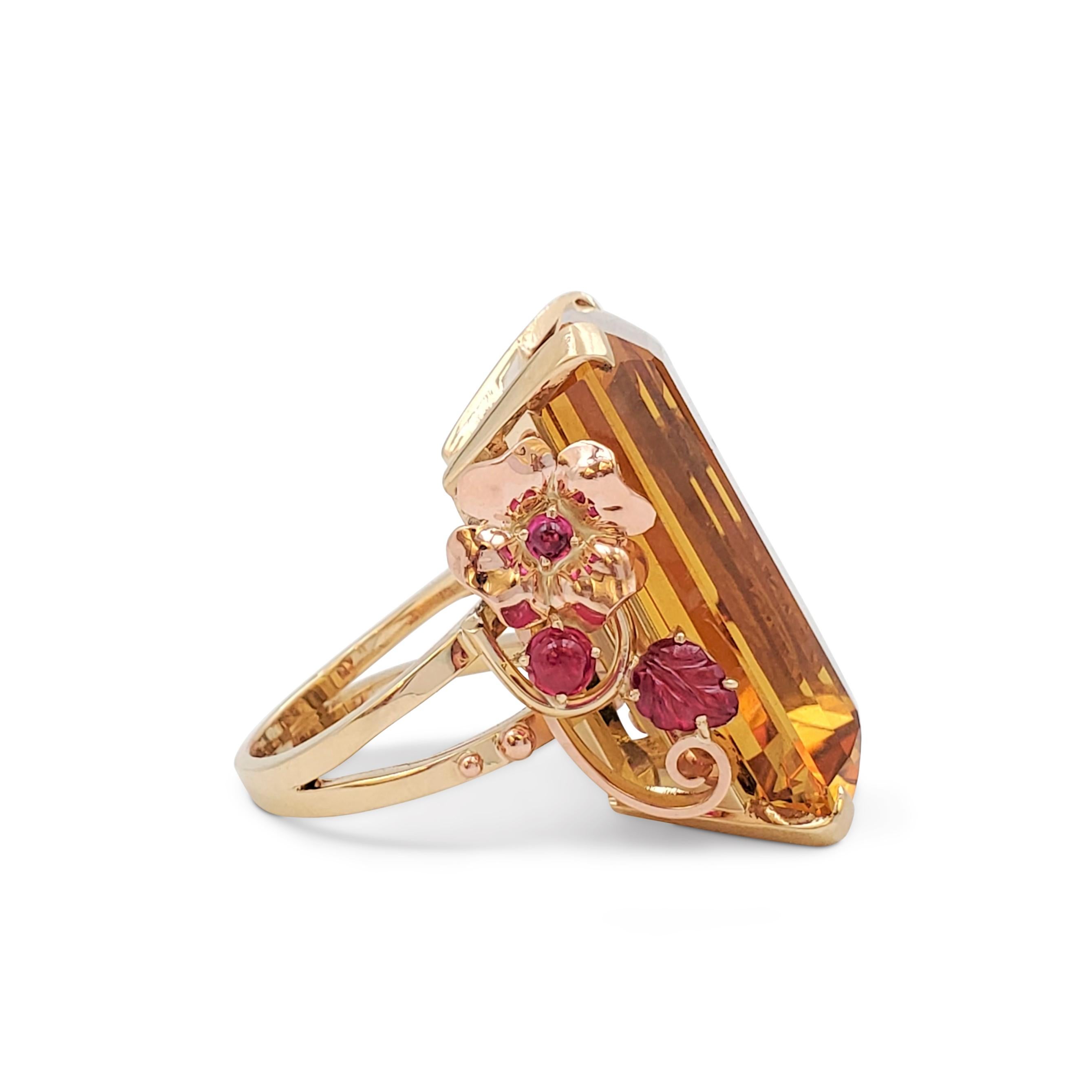 A statement-making retro cocktail ring crafted in 14 karat tri-colored gold centers a delicious honey-colored 57.86-carat rectangular-cut citrine stone. Each side of the ring mounting features design elements typical of the time period.  The