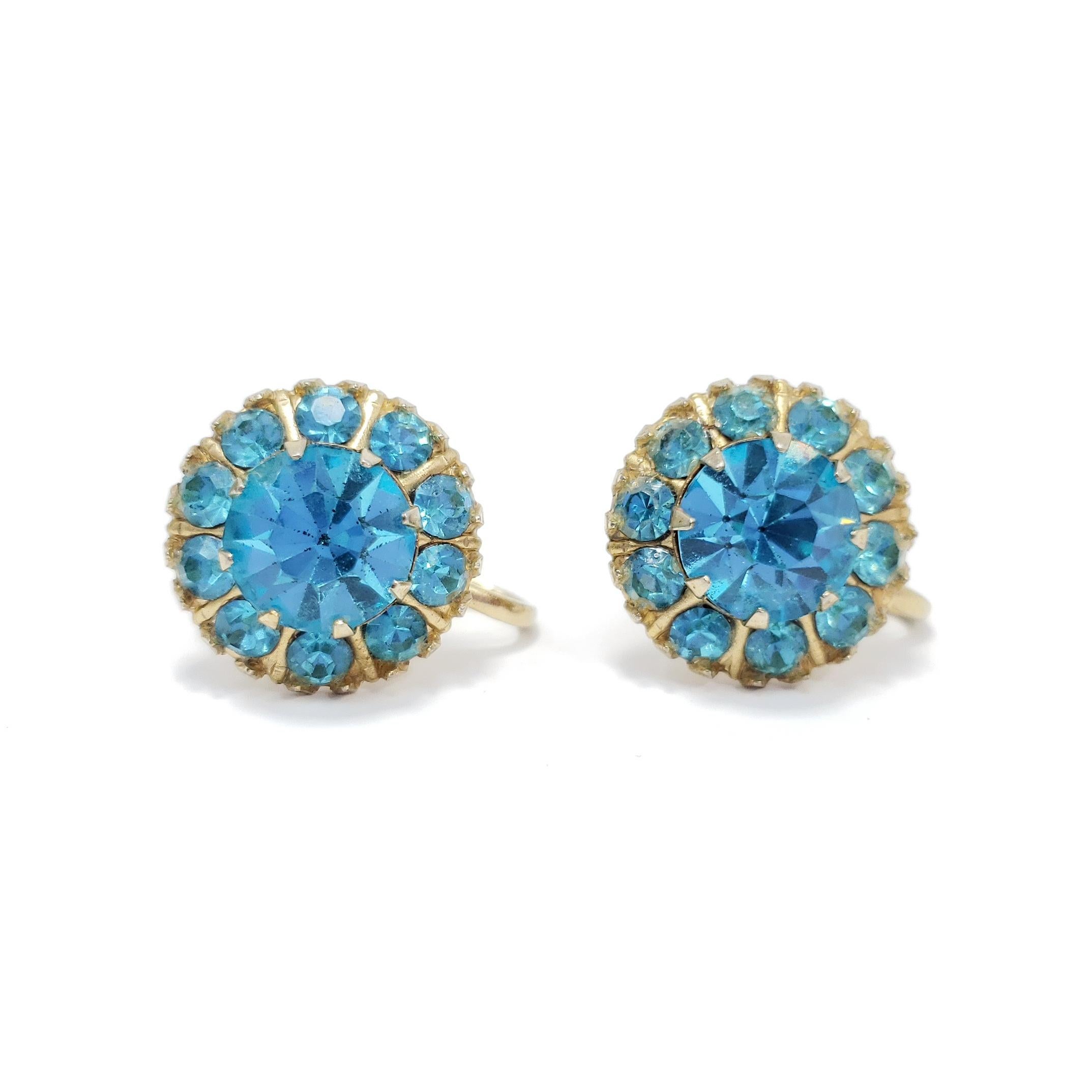 A touch of retro flair! These golden earrings are decorated with sparkling turquoise crystals.

Screw back closure. Circa mid 1900s.

Gold-plated.