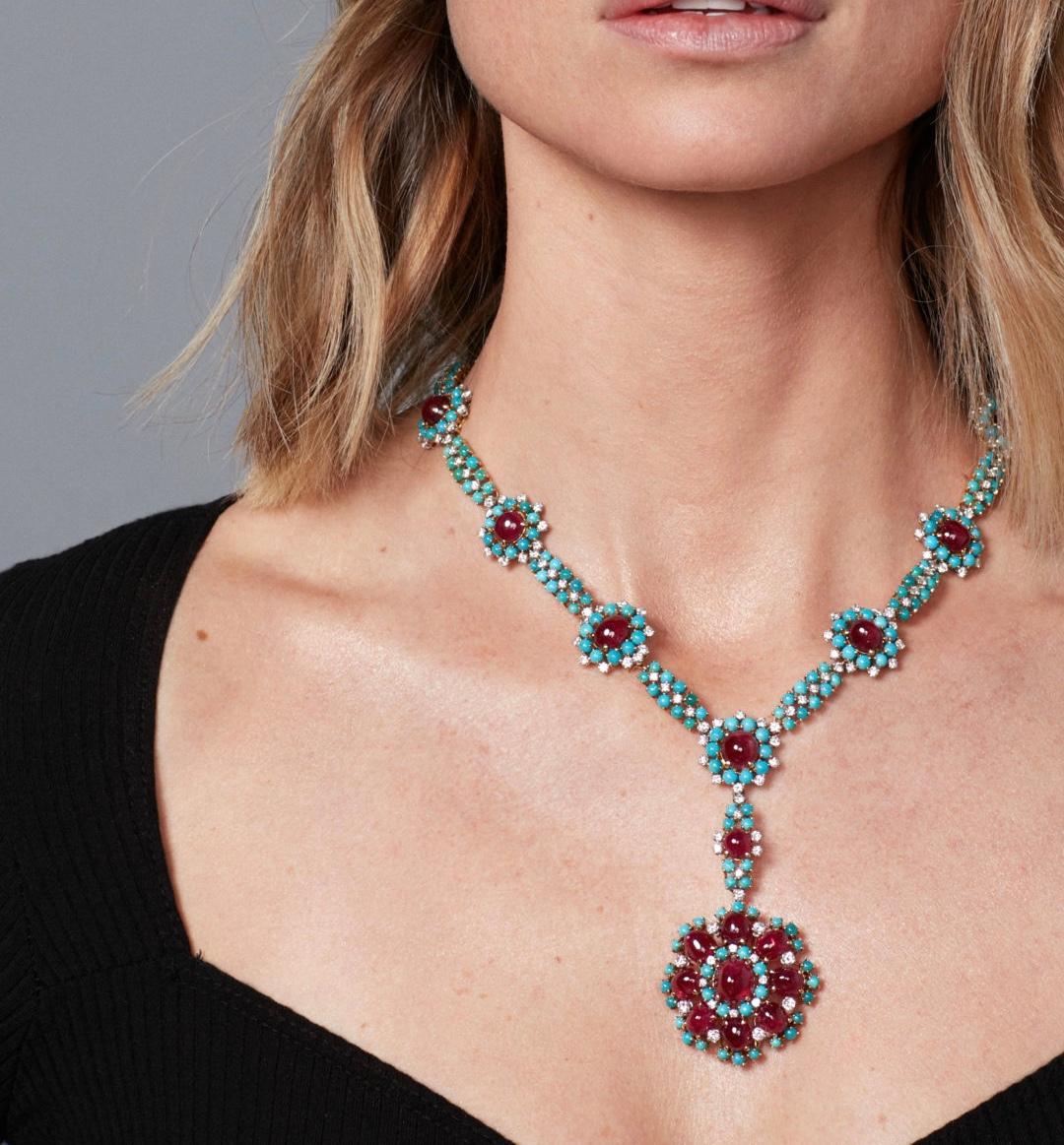 A refined retro necklace set throughout with cabochon turquoise highlighted with cabochon cut rubies, further enhanced with brilliant-cut diamonds (app. 4-4.5 cts) , length approximately 430mm; with French assay marks for gold and maker’s marks.