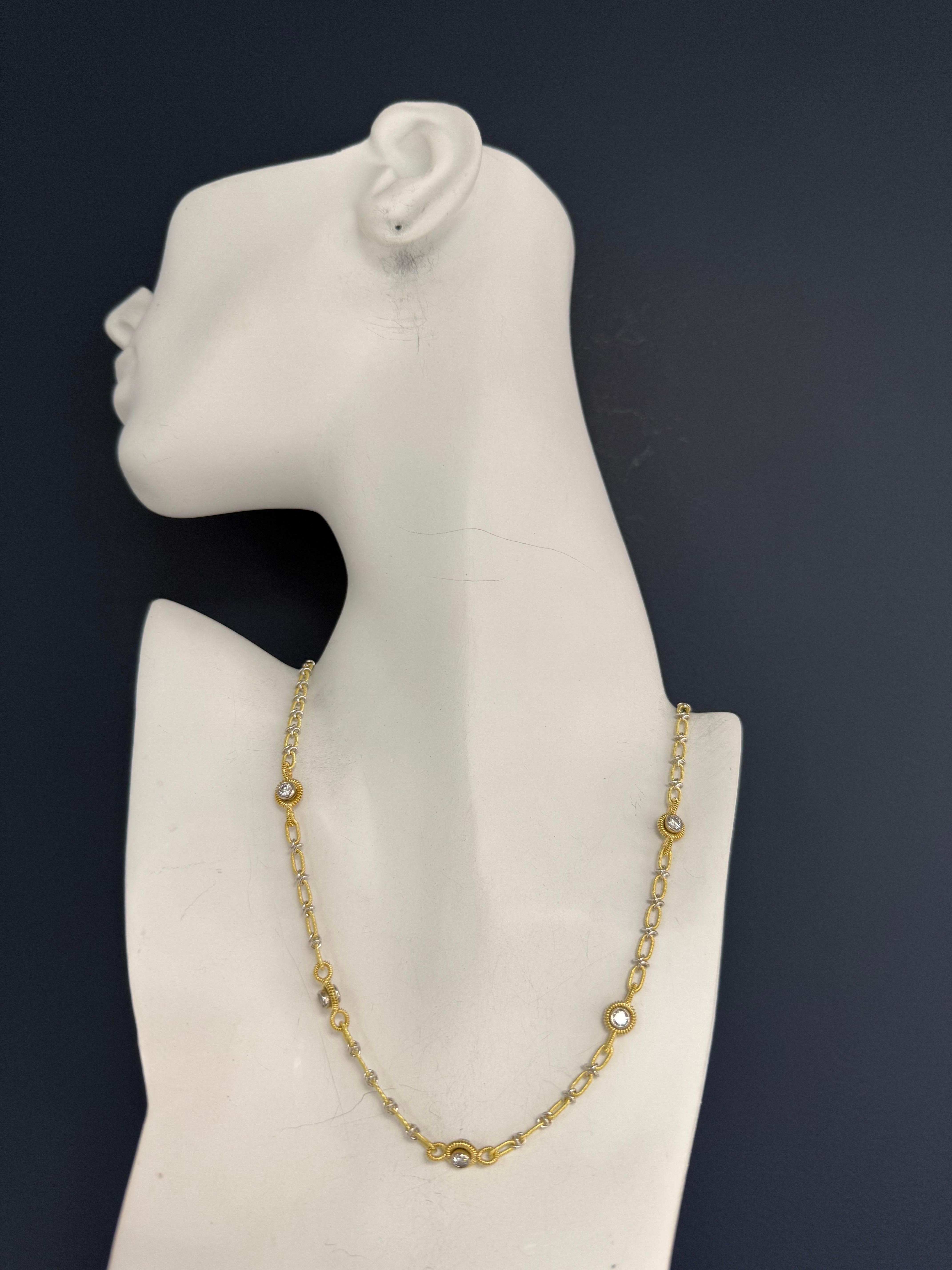 A retro 18K yellow and white gold statement necklace set with approximately 1.50 carats of natural round brilliant diamonds. The piece features ten diamonds mounted in five double-sided bezel settings, with one diamond exposed on each side for a