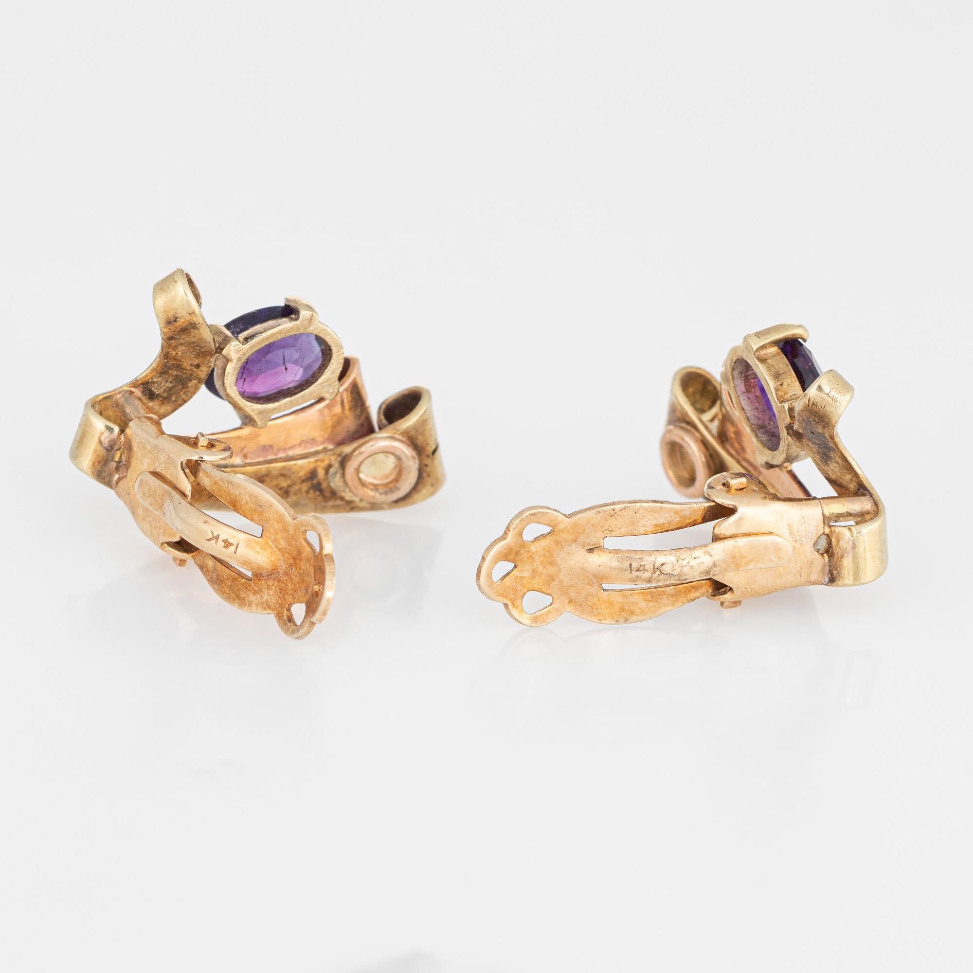Elegant pair of retro vintage amethyst earrings (circa 1940s) crafted in 14k yellow & rose gold. 

Oval cut amethysts each measure 7mm x 5mm (0.65 carats each - 1.30 carats total estimated weight). The amethysts are in very good condition and free
