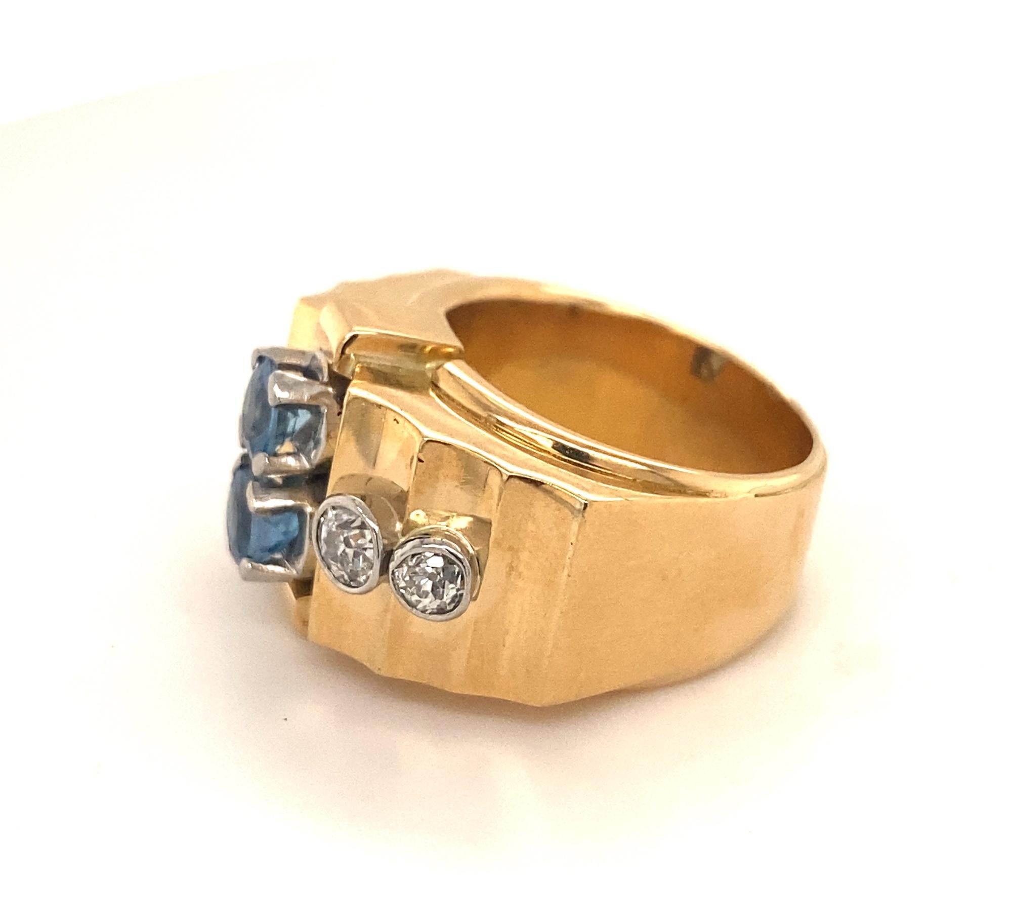 This is a beautiful retro vintage ring C.1950’s.  The ring has a unique design set with 4 old mine cuts and 2 aquamarines.  The diamonds are white clean old mine cuts that average H Color SI-1 clarity total weight .80 carats.  The two aquamarines