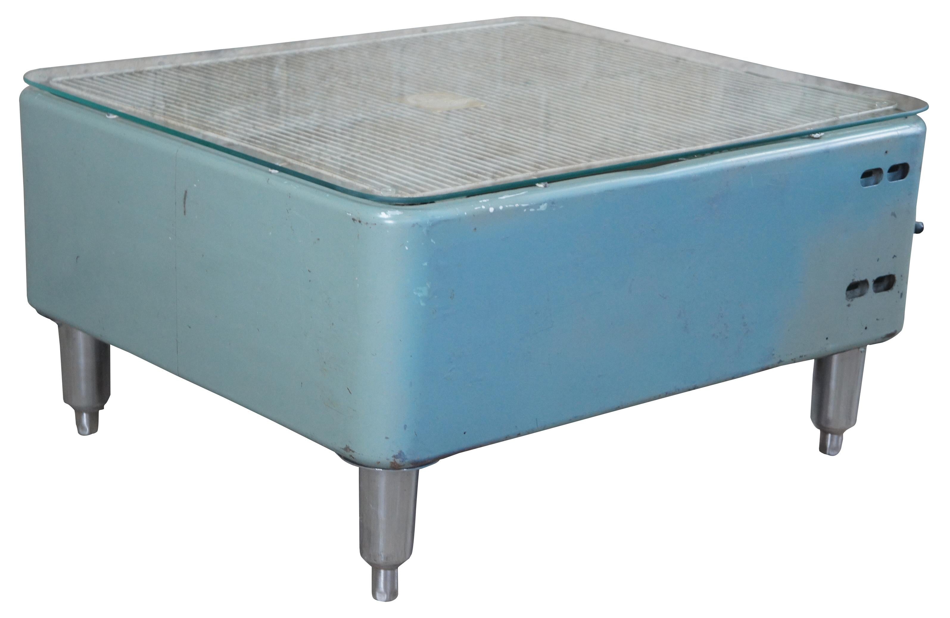 Vintage Industrial Lau box fan table. Square form with adjustable legs and a glass top.

Measure: Height - 16.5