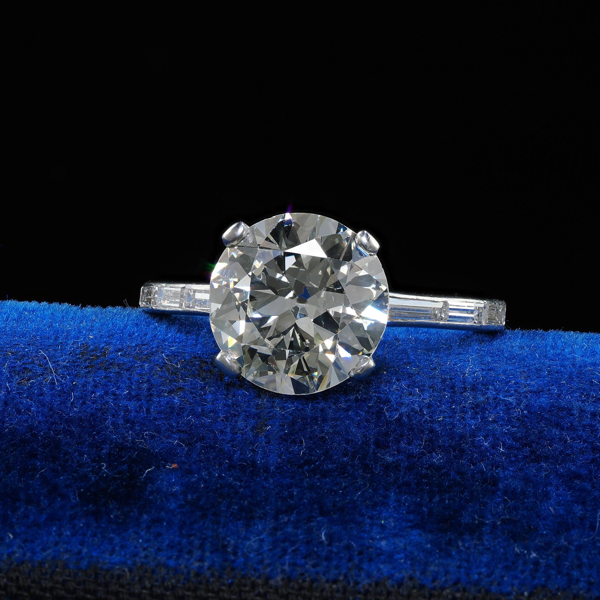 Beautiful Retro Vintage Platinum Transitional Cut Diamond Baguette Engagement Ring - GIA. This incredible Retro engagement ring is crafted in platinum. This gorgeous ring features an old transitional cut diamond in the center that has a GIA report.